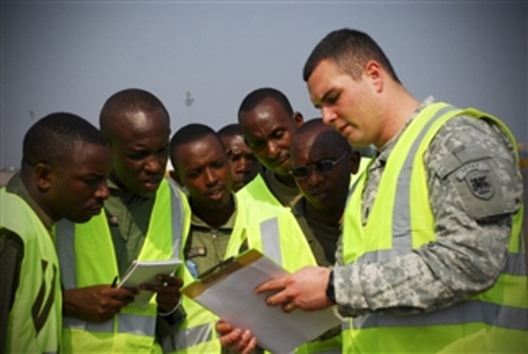 U.S. Army 1st Lt. Charles Jones from Headquarters Support Company, Southern European Task Force explains scaling and labeling procedures to soldiers from the Rwanda Defense Forces in Kigali, Rwanda, on Jan. 13, 2009, prior to their deployment to Sudan in support of an African Union/United Nations peacekeeping mission.  Jones is in Rwanda to conduct pre-deployment training as part of the Africa Deployment Assistance Phased Training program, which is designed to help African militaries deploy and support forces participating in African Union/United Nations peacekeeping operations.  Rwanda has more than 3,200 troops deployed to Sudan in support of the mission.  