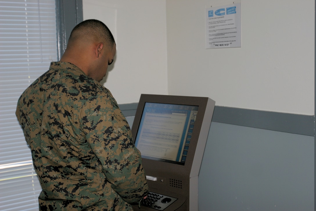 Sgt. Job R. Vargas, 9th Communication Battlion, utilizes the local ICE kiosk at the 14 Area Installation Personnel Adminstration Center after he was provided service. The kiosk provides a simple way to rate and comment on the service's received on base.  ::r::::n::