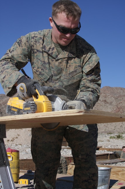 Lance Cpl. Michael King, a Range/Training Areas Maintenance Section worker, saws plywood to be used for constructing a trench at Combat Center Range 400 Jan. 15. Units participating in Mojave Viper, the base’s 30-day pre-deployment training package, use Range 400 to practice coordinating platoon and company-sized attacks against enemy objectives using a combined force of infantry, mortars and machine guns. RTAMS maintains these ranges and began duplicating them Dec. 11 so multiple infantry battalions can train simultaneously.