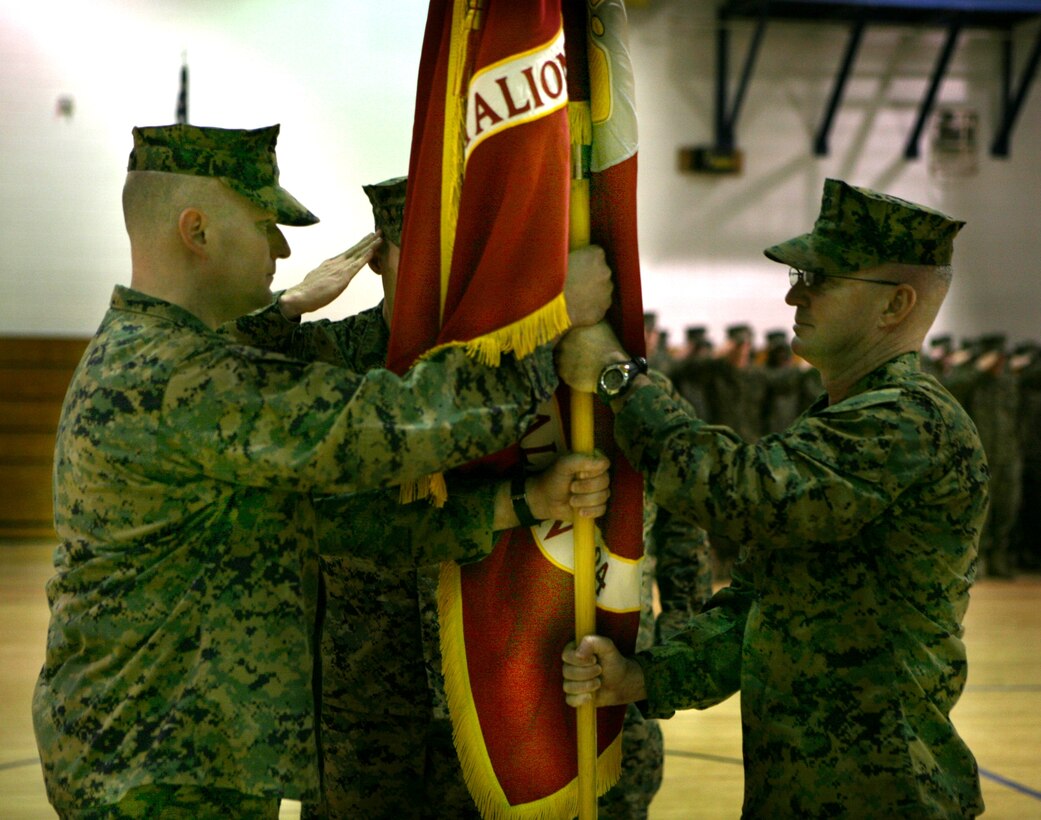Lt. Col. Ricky F. Brown, the outgoing commander of Combat Logistics Regiment 24, passes the unit guidon to Lt. Col. Scott D. Sutton at a change of command ceremony, here, Jan. 15.  Brown first assumed command over CLB-24 in February 2007.