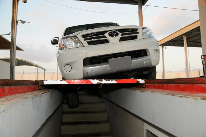 SOUTHWEST ASIA -- A vehicle sits with one wheel in a vehicle inspection pit after an accident here. A minor vehicle accident can result in seven to 12 hours of additional work for 380th Air Expeditionary Wing personnel and a major accident can add 16 hours to several days of work. (U.S. Air Force photo by 1st Lt. Michael Frye) (Released)