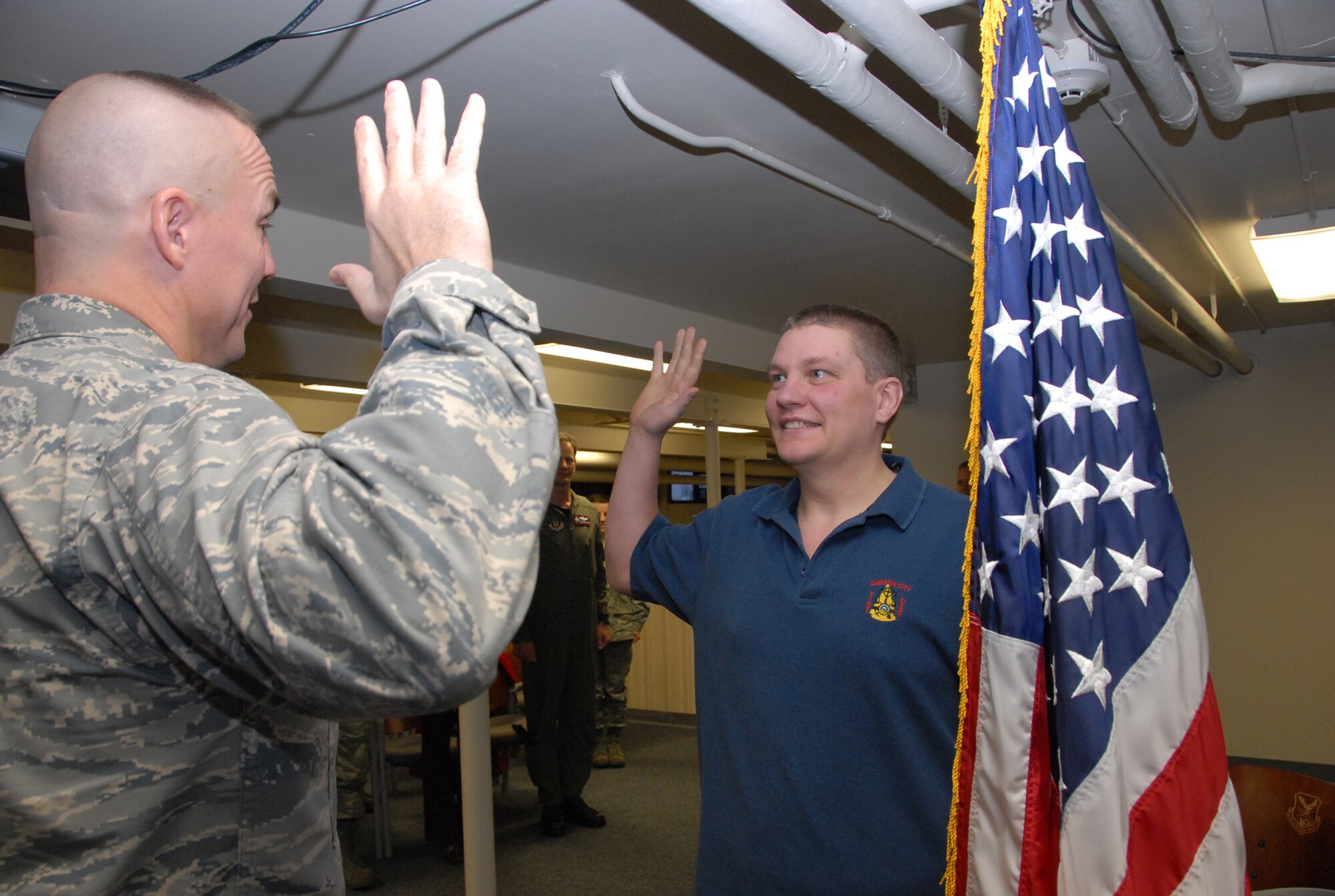 Derrick Bell enlists in the Air Force Reserve Jan. 15.  Bell is the newest enlisted member of the 477th Fighter Group, a Classic Associate unit responsible for recruiting, training, developing and retaining unrivaled Citizen Airmen.  In only 11 months Bell lost 115 pounds before he met physical standards for the Air Force Reserve.  Today he is preparing to attend technical training to work as an F-22A Raptor Crew Chief. (U.S. Air Force photo by Staff Sgt. Rhiannon Willard)