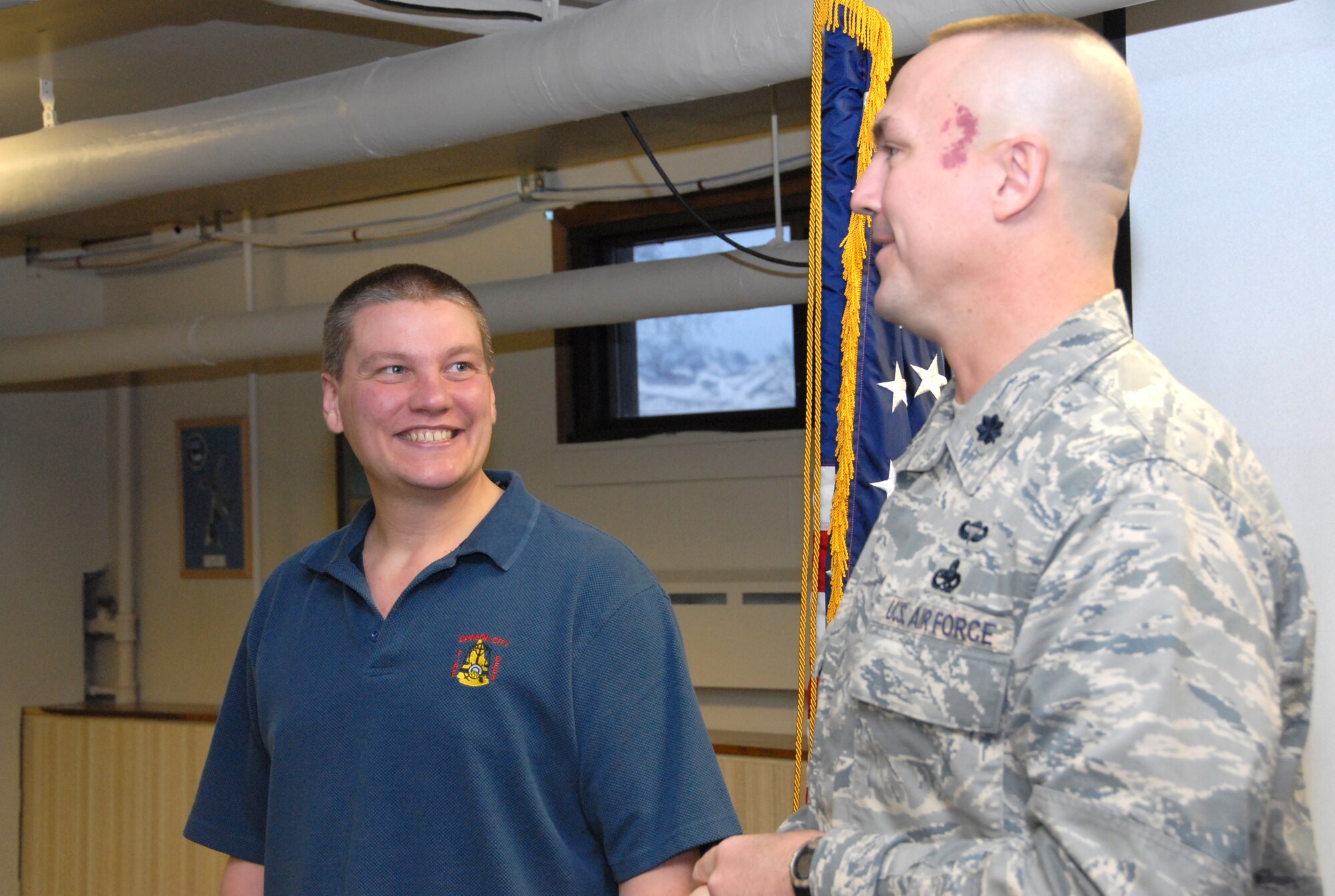 Derrick Bell stands with Lt. Col. Raymond Platt, 477th Aircraft Maintenance Squadron Commander, during his enlistment ceremony Jan 15 .  Bell is the newest member of the 477th Fighter Group, a Classic Associate unit responsible for recruiting, training, developing and retaining unrivaled Citizen Airmen.  In only 11 months Bell lost 115 pounds before he met physical standards for the Air Force Reserve.  Today he is preparing to attend technical training to work as an F-22A Raptor Crew Chief. (U.S. Air Force photo by Staff Sgt. Rhiannon Willard)