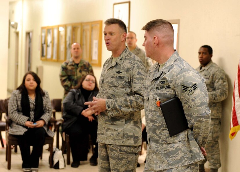 DYESS AIR FORCE BASE, Texas -- Colonel Robert Gass, 7th Bomb Wing Commander, honors Senior Airman Gerald Basel, 7th Security Forces Squadron, during a medal presentation here, Jan. 13. Airman Basel earned the Air Force Combat Action Medal for his engagement against insurgents while deployed to Iraq. (U.S. Air Force photo by Airman 1st Class Stephen Reyes)