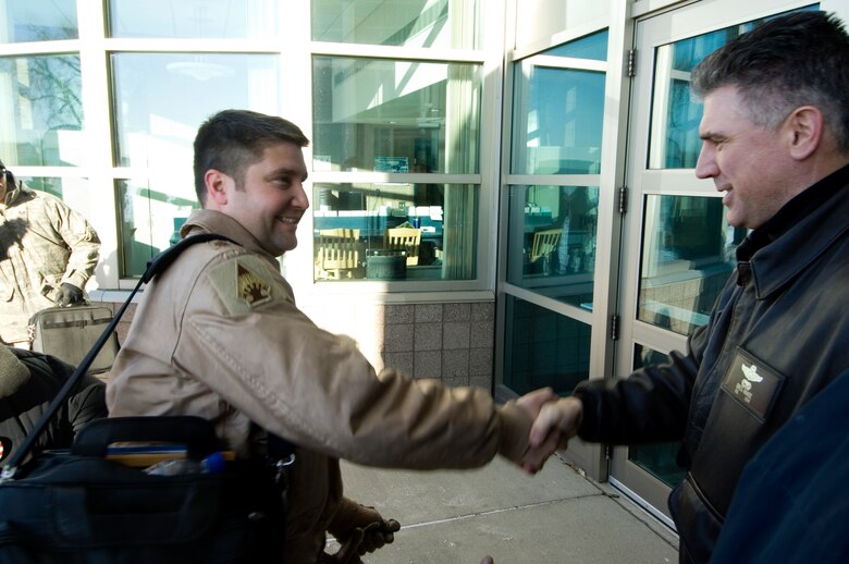 133rd Airlift Wing Commander Colonel Greg A. Haase (right) shakes hands with  Maj. Jeffrey Wong (left) upon arrival at the 133rd Operations building 14 January 2009. Major Wong piloted the Minnesota Air National Guard C-130 Hercules that returned from deployment to Afghanistan supporting Operation Enduring Freedom. (U.S. Air Force photo/Tech. Sgt. Erik Gudmundson) 