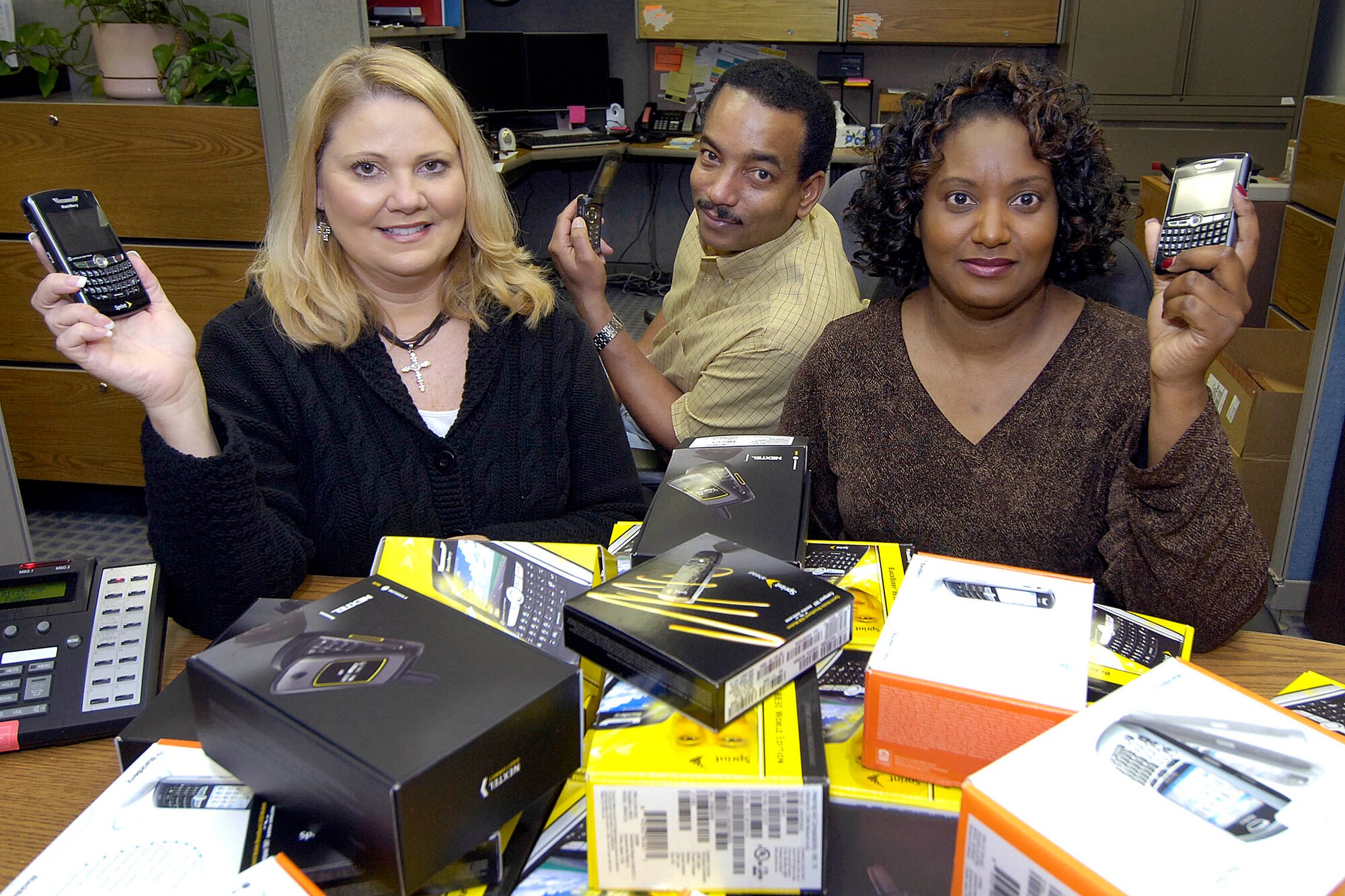 Keeping the blackberry patch wired

Love to hate your government BlackBerry or cell phone, but know you can’t function without it? Thank the “BlackBerry Team” of the 72nd Communications Squadron.  Tammy Dillard, Hank Kennedy and Lisa Robertson, from left, are the people who keep you communicating anywhere you roam. These communications systems managers serve all of Tinker’s wireless communicators, including aircards, and manage a database on their more than 1,600 customers. Located in Bldg. 3001G, they handle initial requests for the devices, prepare the units, act as go-betweens from the service carriers to the users and help when customers forget their passwords. (Air Force photo/Margo Wright)

