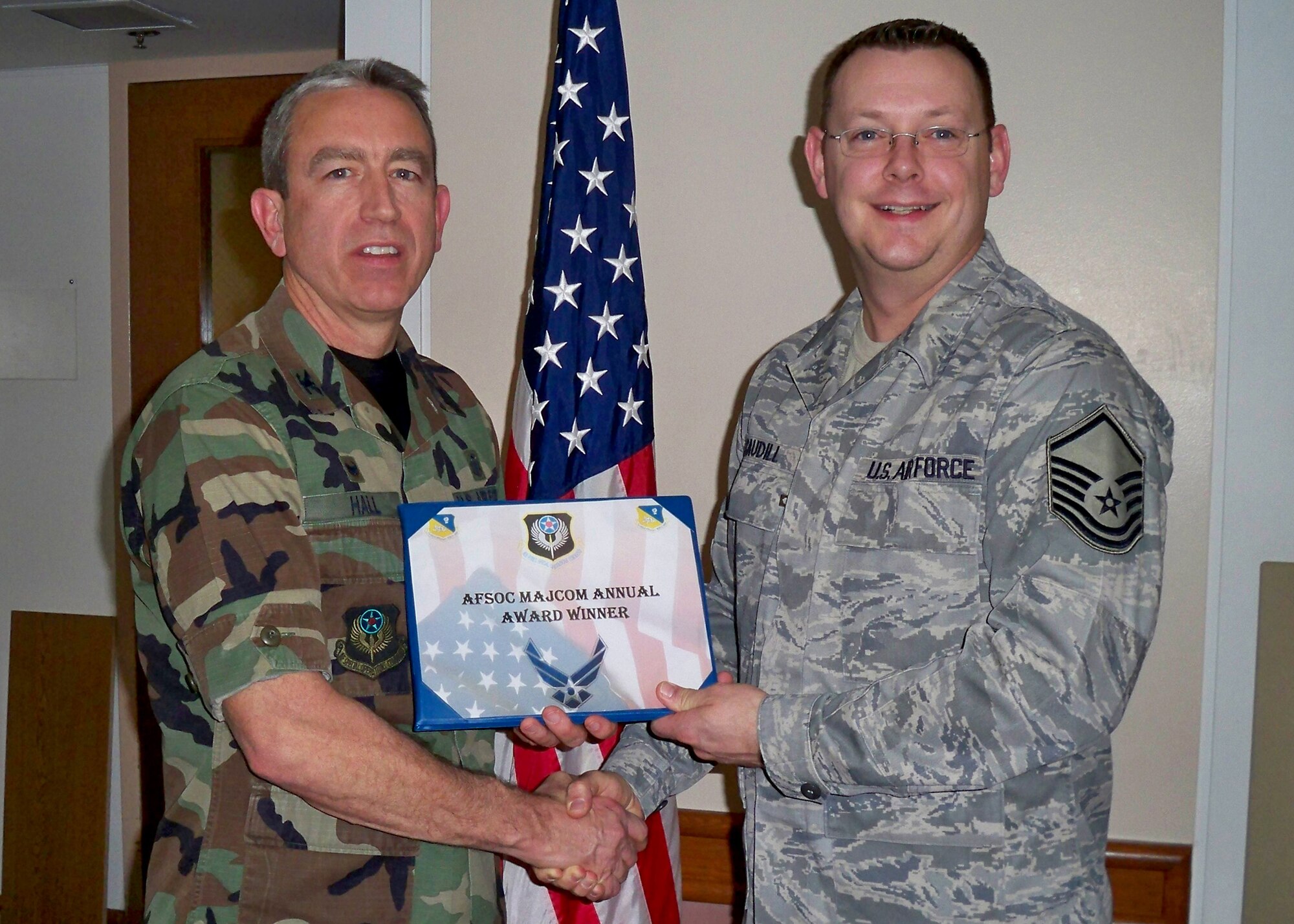CANNON AIR FORCE, N.M.-- Col. Kenneth Hall, 27th Special Operations Medical Group commander, presents Master Sgt. Larry Caudill, 27th Special Operations Aerospace Medicine Squadron, with the 2008 Air Force Special Operations Command Outstanding Dental Senior NCO Award Jan. 8 at the medical clinic. Sergeant Caudill was also nominated for the United States Air Force Outstanding Dental SNCO of the Year Award. (Courtesy photo)