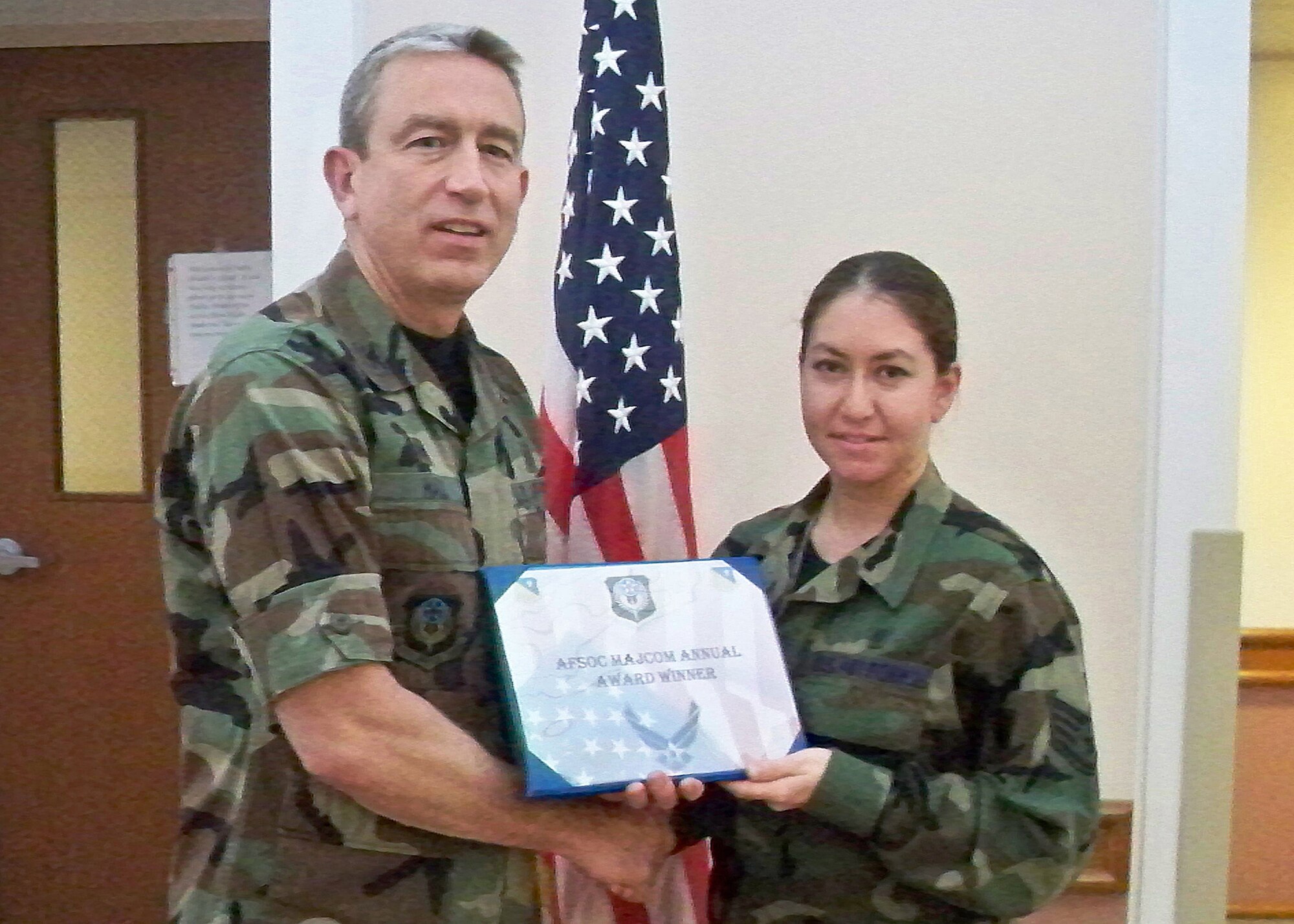 CANNON AIR FORCE BASE, N.M.-- Col. Kenneth Hall, 27th Special Operations Medical Group Commander, awards Staff Sgt. Oralia Buenrostro, 27th Special Operations Medical Support Squadron, the 2008 Air Froce Special Operations Command Biomedical Equipment Repair Airman Award Jan. 8. Sergeant Buenrostro was also nominated for the United States Air Force Outstanding Biomedical Equipment Repair Airman of the Year Award. (Courtesy photo)