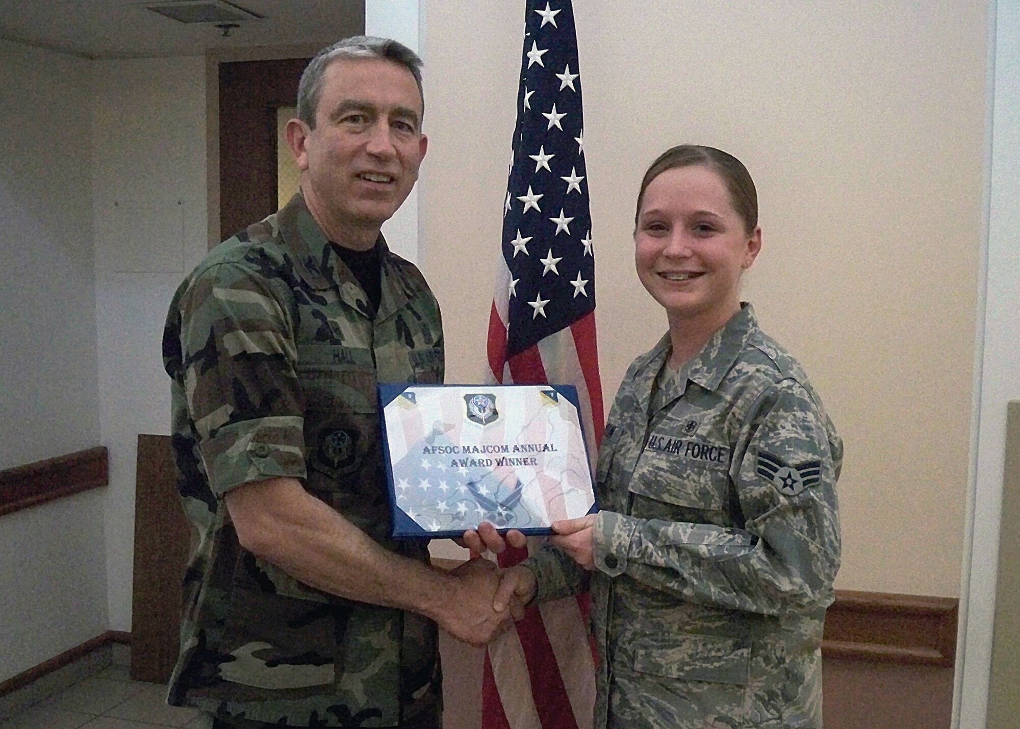 CANNON AIR FORCE BASE, N.M. -- Col. Kenneth Hall, 27th Special Operations Medical Group commander, presents Senior Airman Ashley Newton, 27th Special Operations Medical Support Squadron, with the 2008 Air Force Special Operations Command Medical Readiness Airman Award on Jan. 8 at the medical clinic. Airman Newton was also nominated for the USAF Outstanding Medical Readiness Airman of the Year Award. (Courtesy photo)