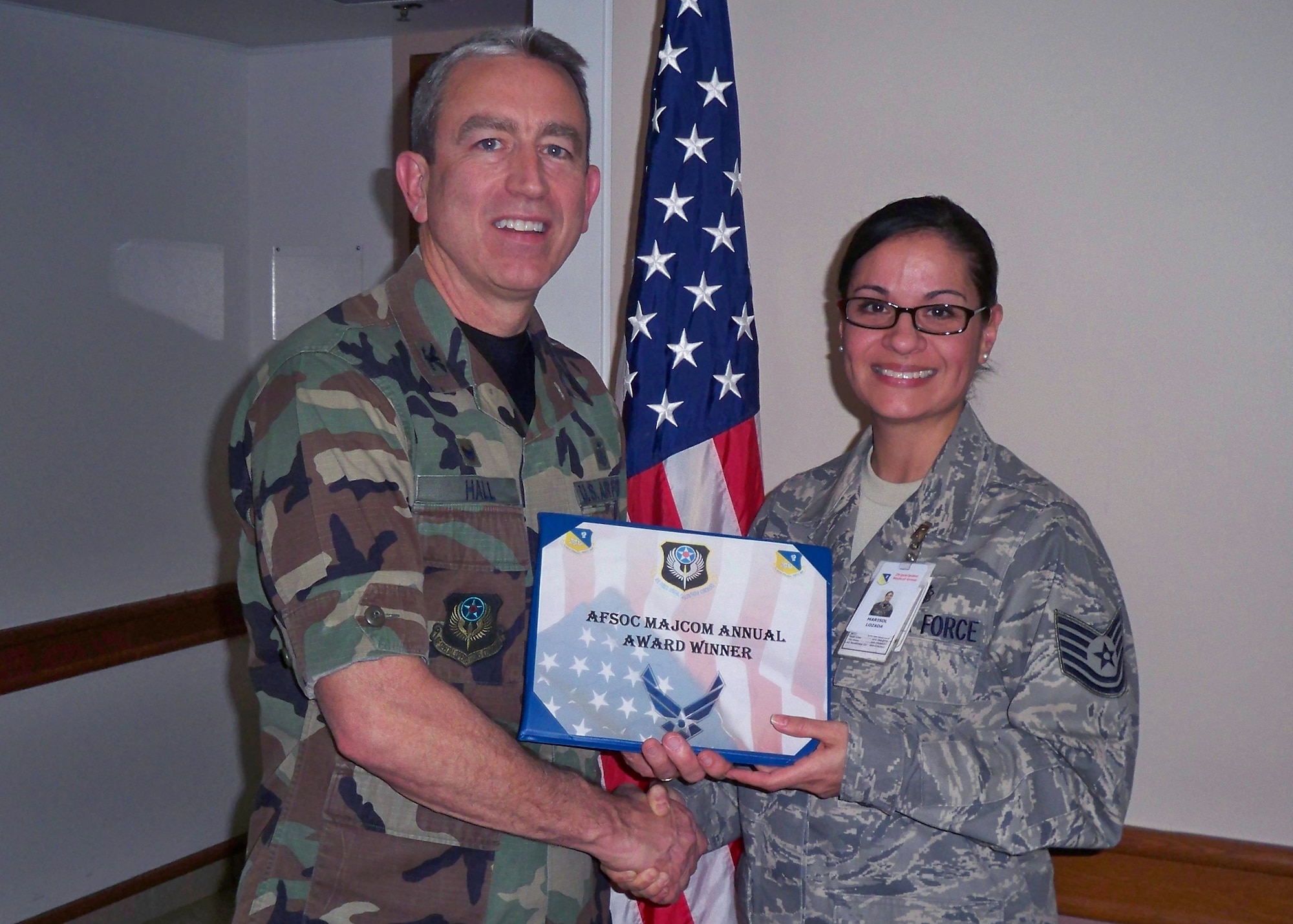 CANNON AIR FORCE BASE, N.M. -- Col. Kenneth Hall, 27th Special Operations Medical Group commander, presents Tech. Sgt. Marisol Lozafa, 27th SOMDG, with the 2008 Air Force Special Operations Command Mental Health NCO Award, at the medical clinic on Jan. 08. Sergeant Lozada was also nominated for the Chief Master Sgt. Lewis W. Dunlap Outstanding NCO of the Year Award.  (Courtesy photo) 