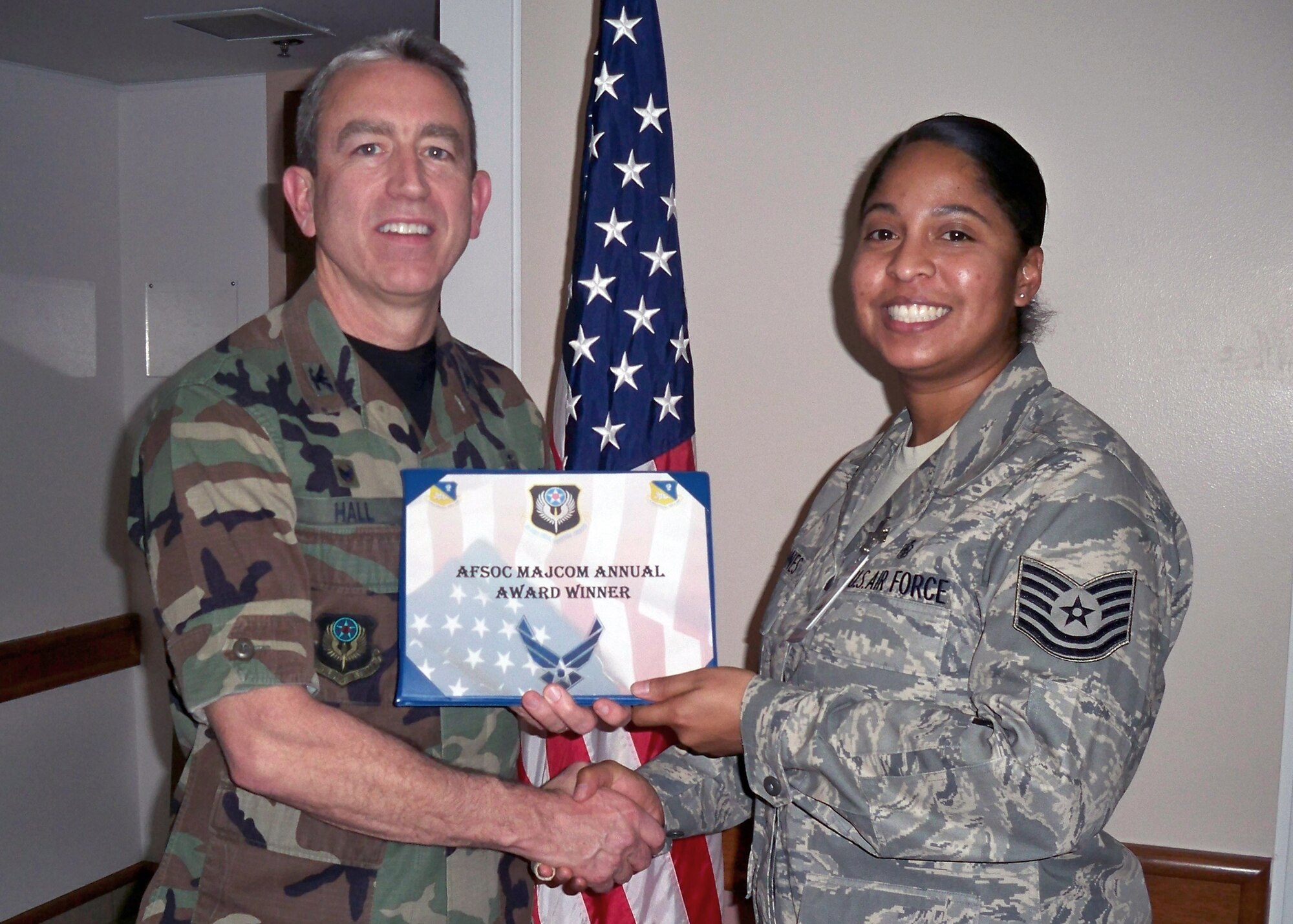 CANNON AIR FORCE BASE, N.M. -- Col. Kenneth Hall, 27th Special Operations Medical Group commander, presents Tech. Sgt. April Gaines, 27th SOMDG, with the 2008 Air Force Special Operations Command Health Plan Management NCO Award, at the medical clinic on Jan. 08. Sergeant Gaines was also nominated for the USAF Outstanding Health Plan Management NCO of the Year Award.  (Courtesy photo) 