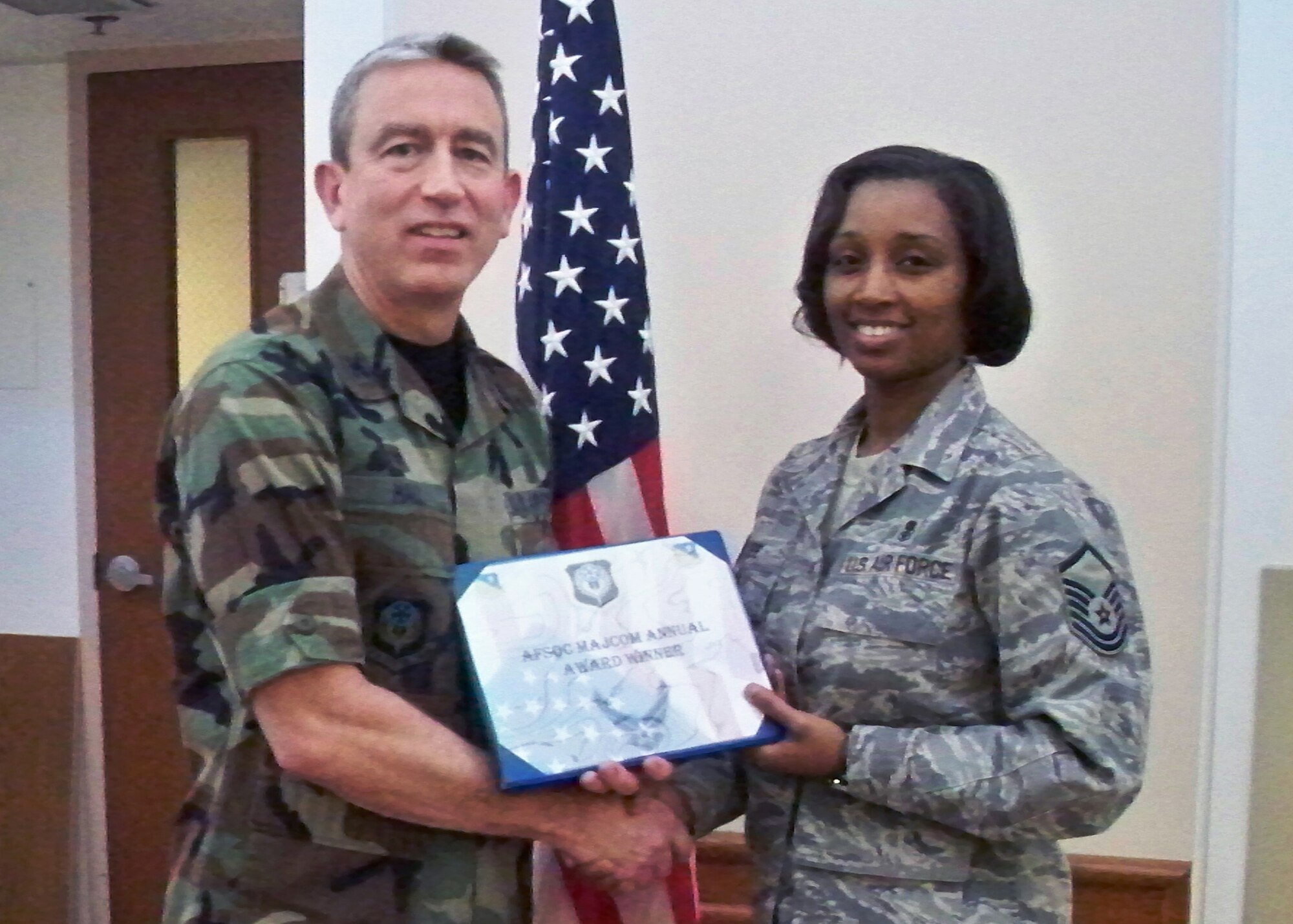 CANNON AIR FORCE BASE, N.M. -- Col. Kenneth Hall, 27th Special Operations Medical Group commander, presents Master Sgt. Andrea Lee, 27th SOMDG, with the 2008 Air Force Special Operations Command Medicine Senior Non-Commissioned Officer Award, at the Medical Clinic on Jan. 8. Sergeant Lee was also nominated for the Olson/Wegner Outstanding Aerospace Medicine SNCO of the Year Award.  (Courtesy photo) 