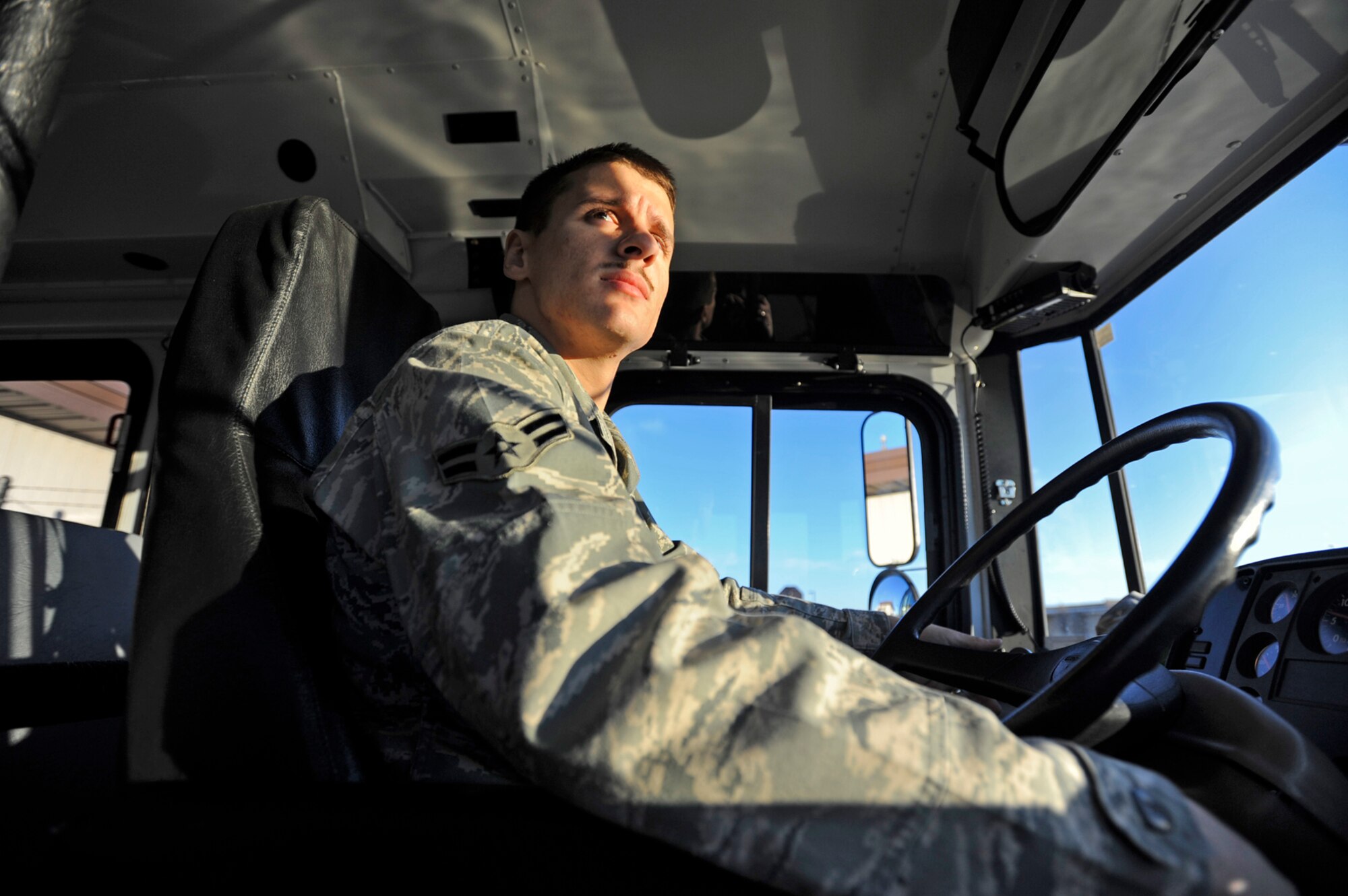 Airman 1st Class Jeremiah Baumgartner looks for traffic at a McConnell Air Force Base, Kan., intersection after delivering a crew of Reserve flyers to the base flightline. Airman Baumgartner is an active-duty vehicle operator assigned to the 22nd Logistics Readiness Squadron at McConnell. The transportation provided by active-duty drivers like Airman Baumgartner is vital to the success of 931st Air Refueling Group missions. The 931st is an Air Force Reserve unit assigned to McConnell. Airman Baumgartner is a native of Brohman, Mich. (U.S. Air Force photo/Tech. Sgt. Jason Schaap)