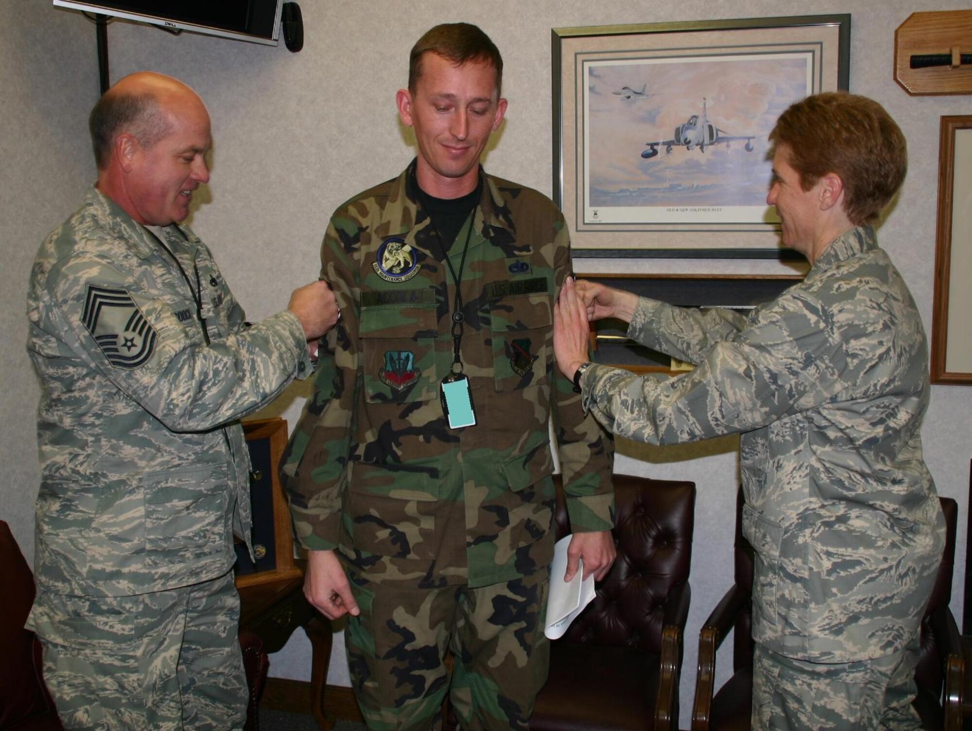 Staff Sergeant John Accola, 552nd Maintenance Squadron, was unexpectedly promoted to technical sergeant by Col. Pat Hoffman, commander, 552 ACW and Chief Master Sgt. Larry Gooch, 552 MXG, while hard at work December 19, 2008.