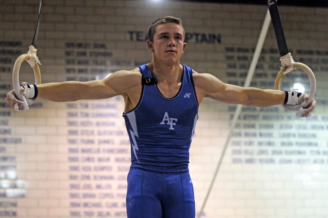 U.S. Air Force Academy senior Jake Schonig executes an iron cross on the still rings during the annual Rocky Mountain Open Jan. 10 at the Academy in Colorado. The Falcons men's gymnastics team accounted for seven top-10 finishes as they placed third overall in the meet in front of a capacity crowd. (U.S. Air Force photo/Mike Kaplan)