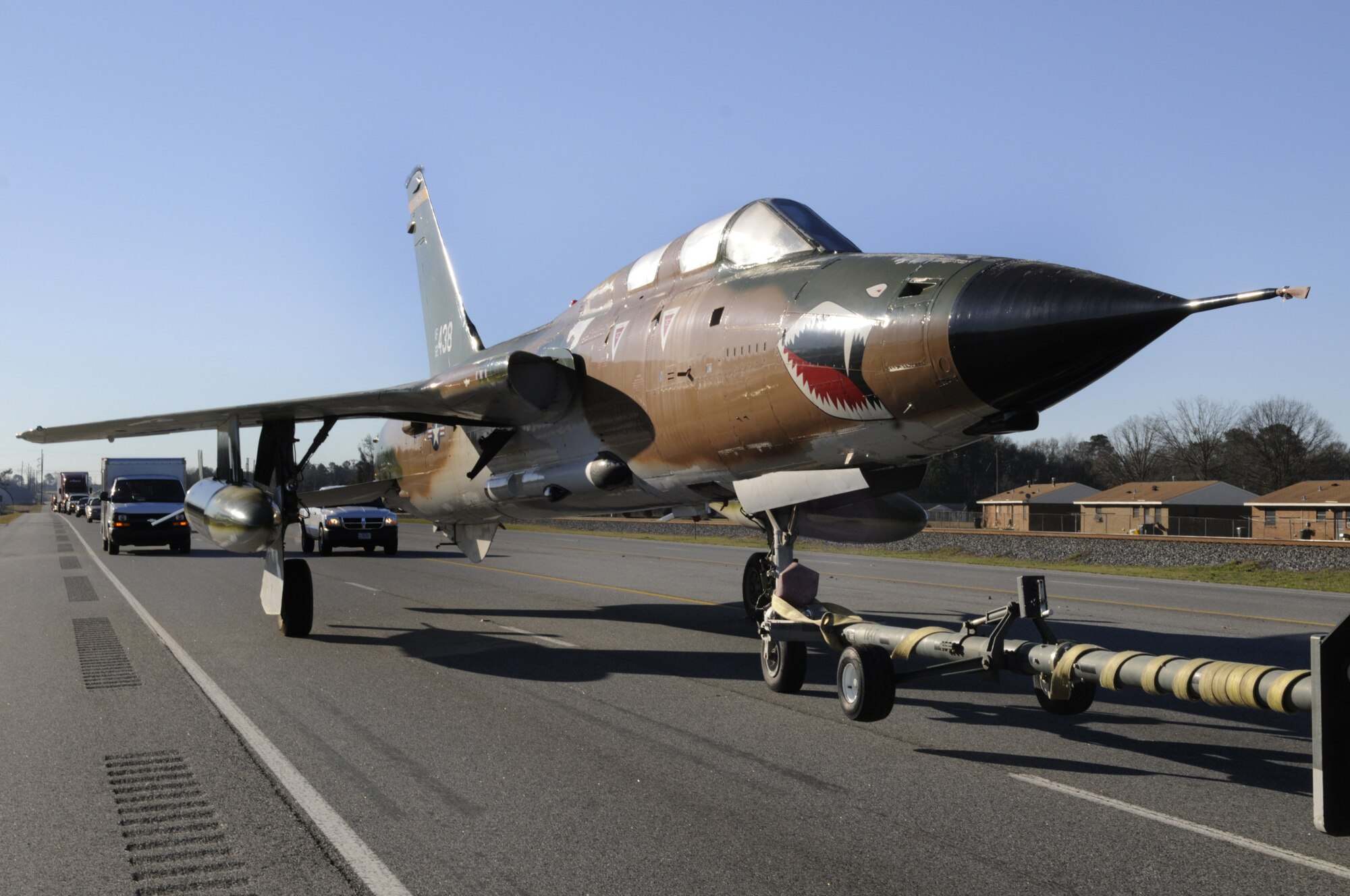 The Museum of Aviation tows an F-105 fighter aircraft down highway 247 Jan 9  from the Russell Parkway gate, north on Highway 247 past Green Street and entering Robins Air Force Base through the perimeter fence near the Aero Club.   The Vietnam War era fighter was taken to the base to be repainted by the 116th Air Control Wing. U. S. Air Force photo by Sue Sapp