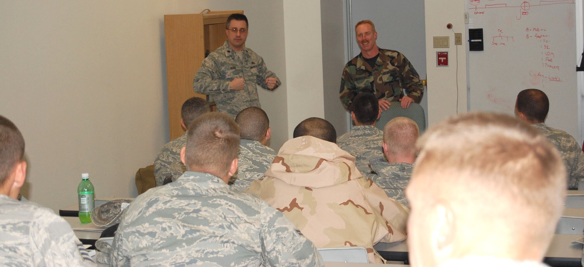 Lt. Col. Timothy Dodge, 341st Civil Engineer commander, and Master Sgt. John McMullen, 341st CES first sergeant, share a lighter moment with their troops who just returned home from a six month deployment to Iraq. (U.S. Air Force photo/Valerie Mullett)
