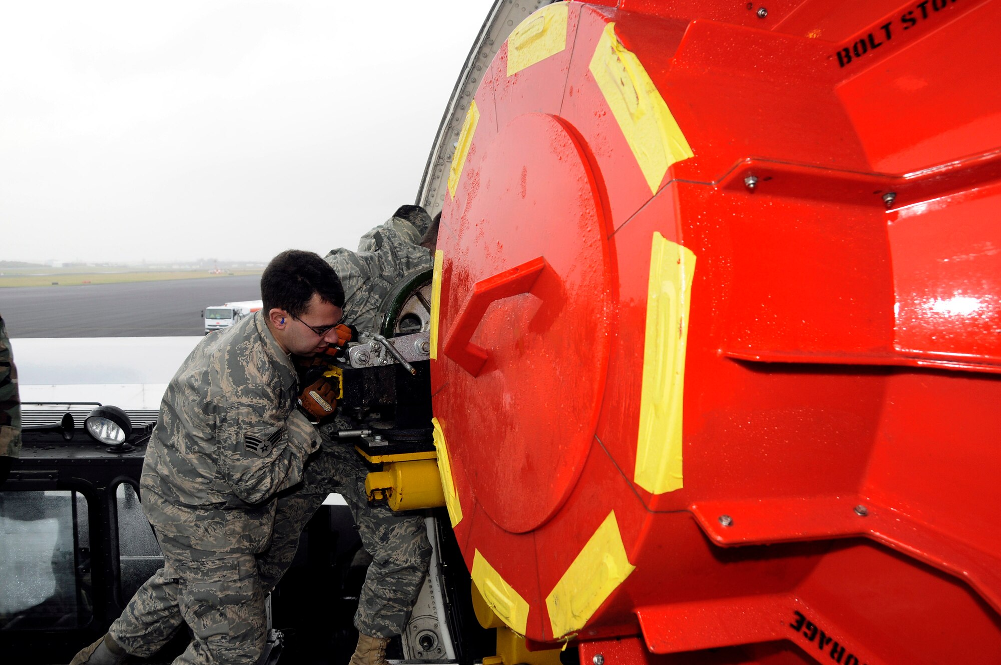 Senior Airman Joseph Harrison and Master Sgt. Eric Pieper assist in loading a defective engine into an Air France 747 cargo plane Jan. 13 at Lajes Field, Azores. Base members assisted the Portuguese and Air France officials in unloading a new engine for an Air France 777 passenger aircraft that made an emergency landing here Jan. 4. Airman Harrison and Sergeant Pieper are assigned to the 729th Air Mobility Squadron. (U.S. Air Force photo/Tech. Sgt. Rebecca Corey) 
