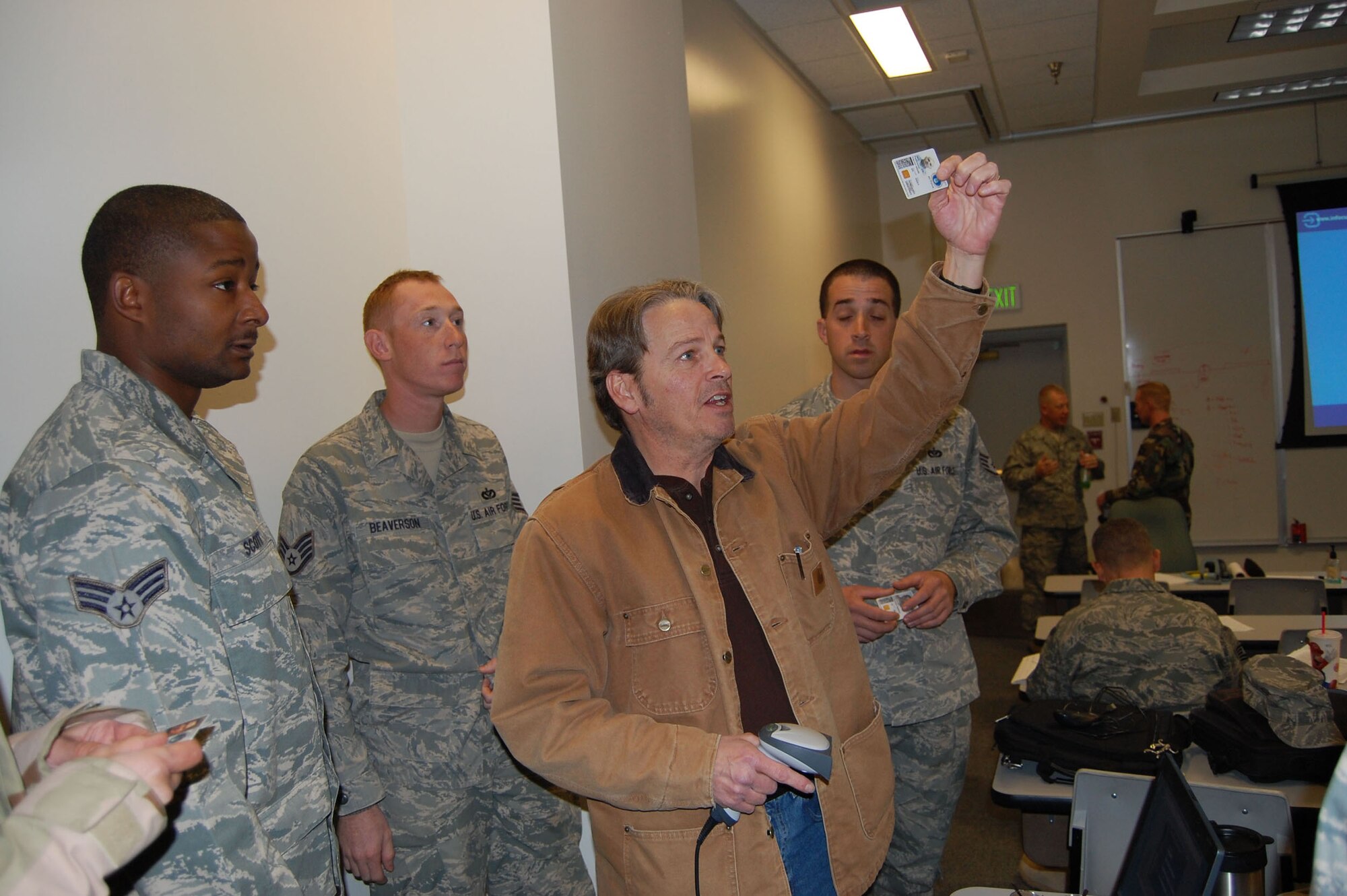 Dave Wrede explains to returning 341st Civil Engineer Squadron members, how their Common Access Card can get damaged in the cold weather. He had to revalidate each of the returning deployed member's CACs during their in-processing briefing Jan. 8. (U.S. Air Force photo/Valerie Mullett)