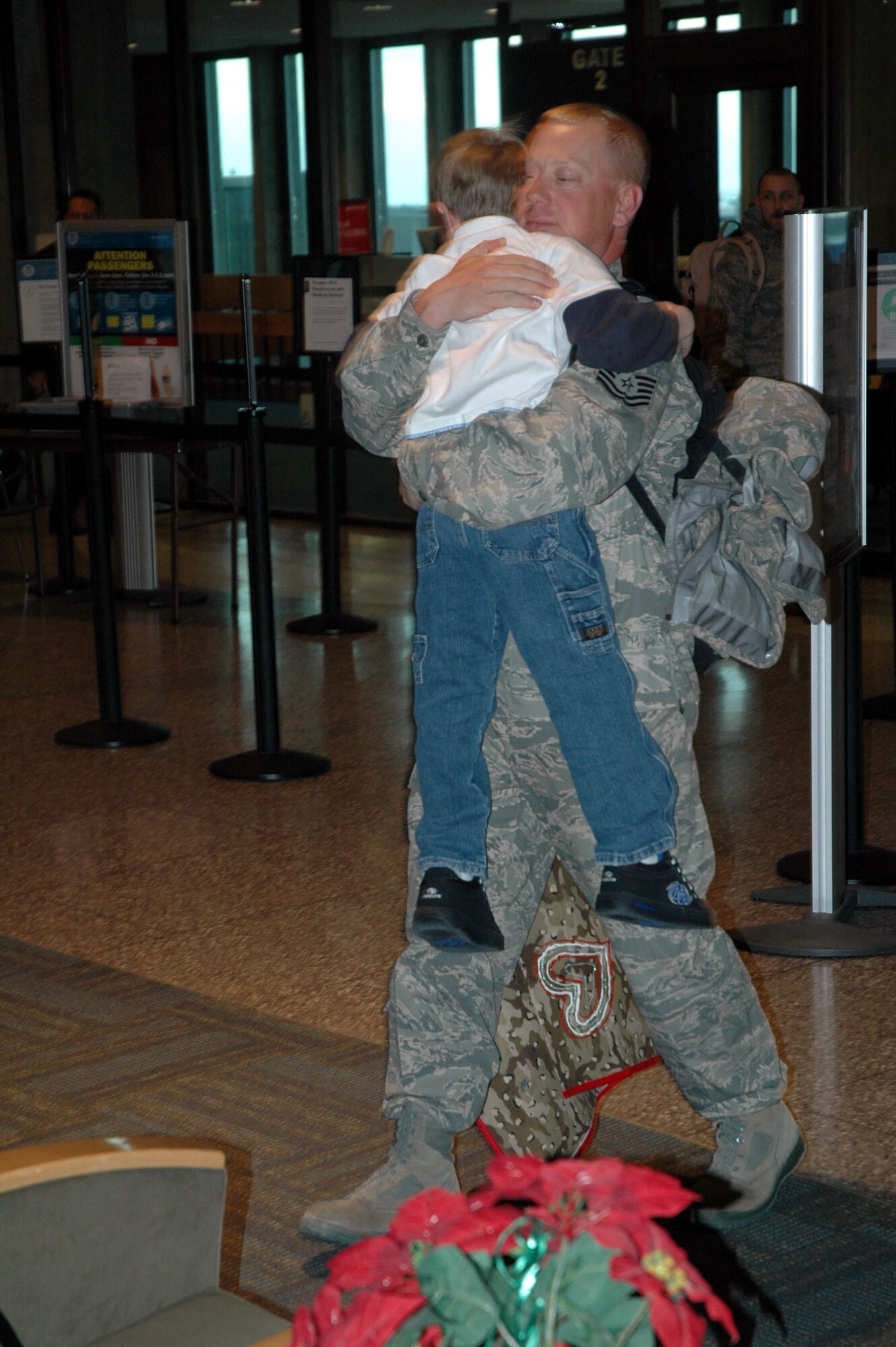 Tech. Sgt. Robert Skiff gets a big hug from his son upon his arrival at Great Falls International airport Jan. 7. Sergeant Skiff and 24 of his 341st Civil Engineer comrades just completed at 179-day deployment to Iraq. (U.S. Air Force photo/Senior Airman Dillon White)