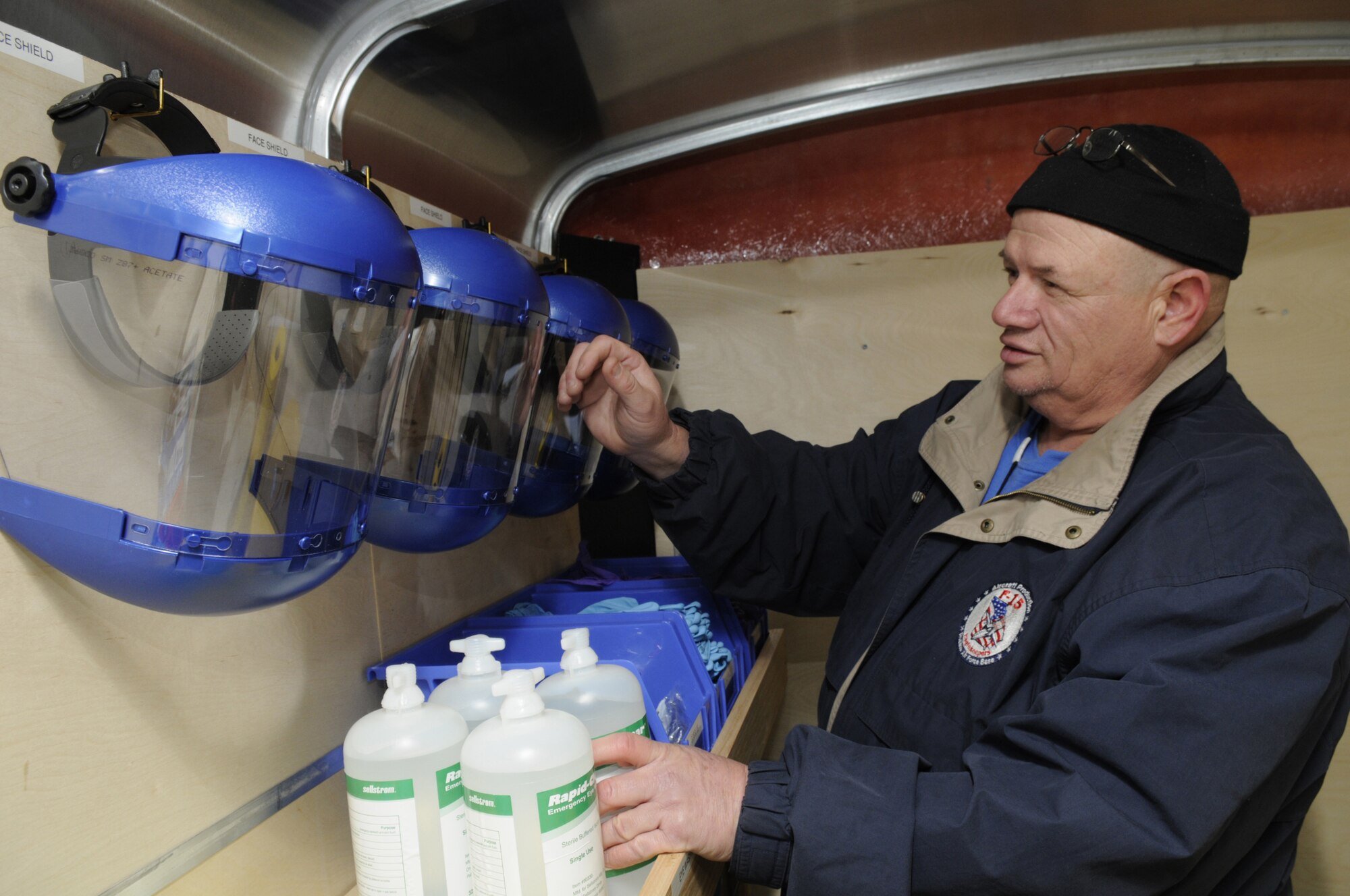 Joe Bossi, environvental specialist, checks the  supplies and protection equipment inside a spill response trailer that workers will need to contain and clean up spills.  U. S. Air Force photo by Sue Sapp