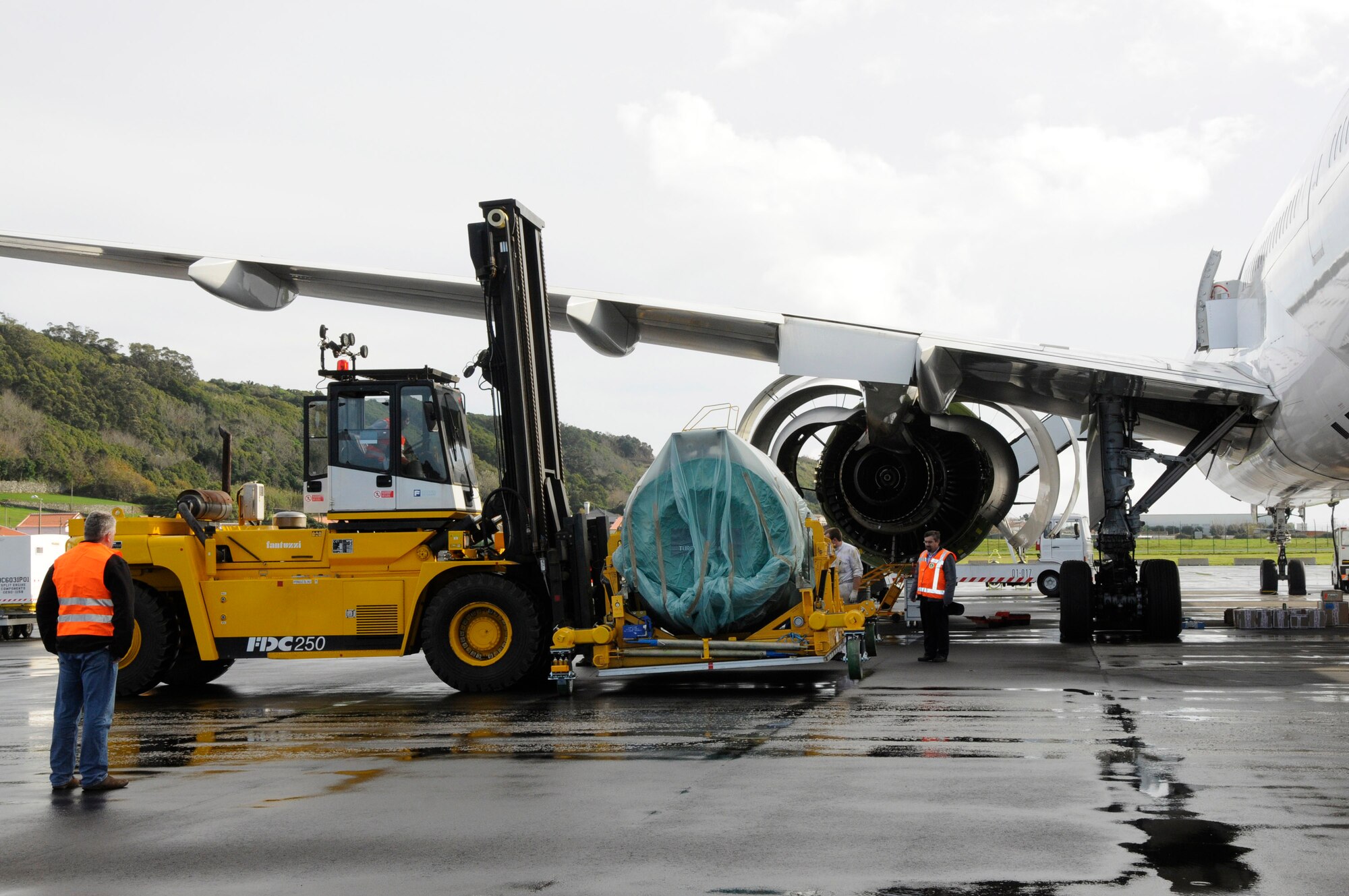 Members of the 838th Transportation Battalion of the Azores Detachment use a forklift to support Air France maintainers move a new 22,000-pound engine for a downed Air France 777 Jan. 6 at Lajes Field, Azores. The aircraft was diverted to Lajes Field Jan. 4. Airmen from Lajes Field and members of the 838th Transportation Battalion were asked to provide support because local commercial airlines here only have lift equipment that can handle up to 15,000 pounds, did not have the capability to support Air France. (U.S. Air Force photo/Guido Melo) 
