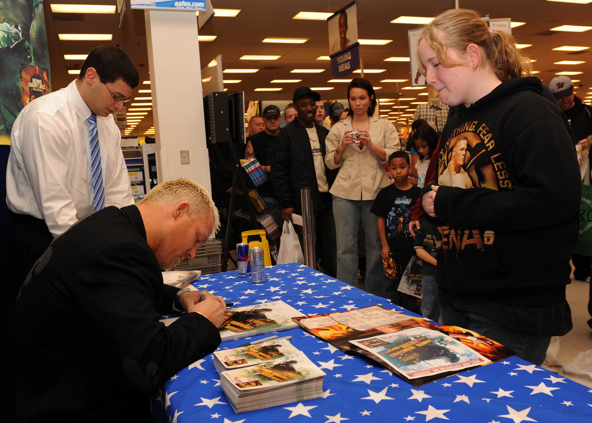 SCOTT AIR FORCE BASE, Ill.-- World Wrestling Entertainment superstar Mr. Kennedy signs an autograph for 13-year-old Amanda Shearer inside the Base Exchange Saturday. Amanda the daughter of Senior Master Sgt. Brian Shearer, U.S. Transportation Command, was among the first to receive an autograph from Mr. Kennedy after waiting in line for his arrival for approximately two hours. Mr. Kennedy is currently on a tour of 6 bases signing autographs and promoting his new movie “Behind Enemy Line: Colombia.” (U.S. Air Force photo/Airman 1st Class Wesley Farnsworth)