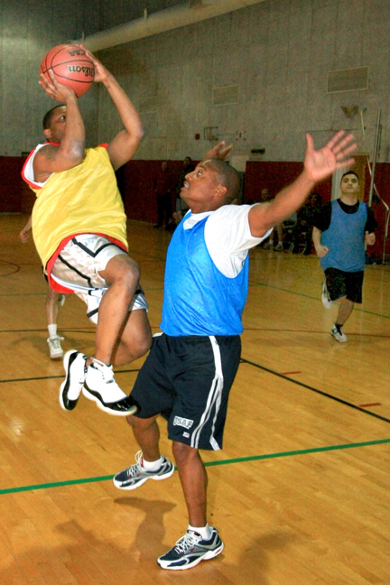 GRISSOM AIR RESERVE BASE, Ind., -- James Poole, Services Squadron, drives to the basket and draws a charging foul as Brandon Williams of the Logistics Readiness Squadron tries to defend.  Poole and his team mates prevailed as Services defeated LRS 34 to 23 in basketball tournament action.  The tournament will continue in February at the Base Fitness Center.  (U.S. Air Force photo/Tech. Sgt. Patrick Kuminecz)