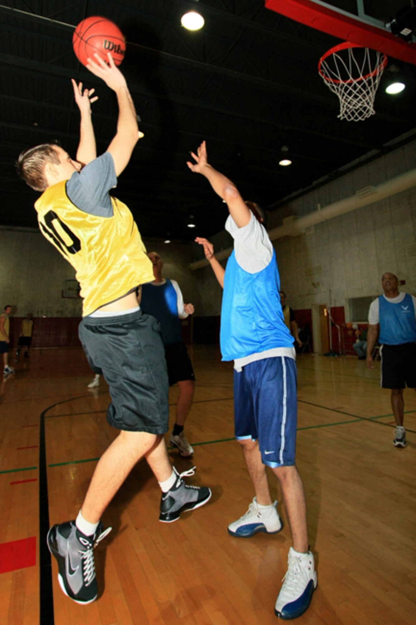 GRISSOM AIR RESERVE BASE, Ind.,--  George Tselos (left), a member of the Services Squadron team, goes for the two points against Brandon Williams, Logistics Readiness Squadron.  Tselos helped his team defeat LRS by a score of 32 to 23 in basketball tournament action held at the Base Fitness Center. (U.S.  Air Force photo/Tech. Sgt. Patrick Kuminecz)