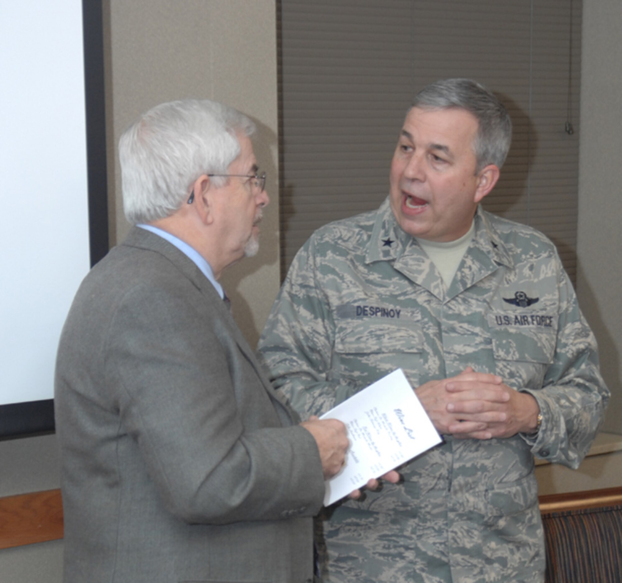GRISSOM AIR RESERVE BASE, Ind., -- Mr. Hal Job (left), president of the Grissom Community Council, and Brig. Gen. Dean Despinoy, 434th Air Refueling Wing commander, compare notes prior the annual "State of the Base" Address.  The event, hosted by General Despinoy, was attended by local elected officials, community leaders, and business representatives who received updated information on the base and its activities.  (U.S. Air Force photo/Staff Sgt. Chris Bolen)
