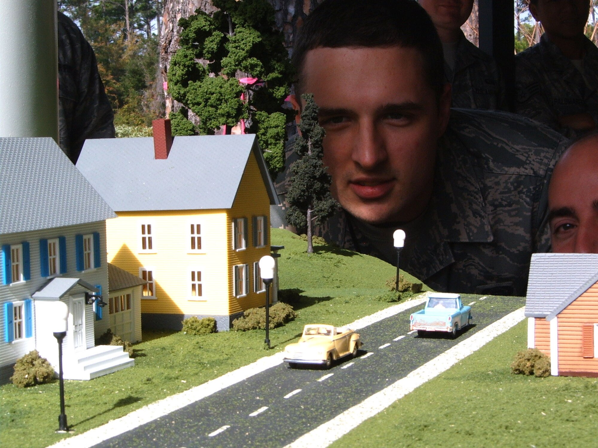 HURLBURT FIELD, Fla ?Students in the Undergraduate Network Warfare Training course at the 39th Information Operations Squadron inspect a model town used in an experiment to depict what could occur if a hacker invaded a water distribution plant?s control network.An off picture laptop acts as a human machine interface that serves to show water supply operators a graphic representation of the overall status of the water distribution.  The simulated hacker was successful in this scenario and caused the water tank to overflow but still showed operators that everything was normal. UNWT represents the most comprehensive network warfare training available in the Air Force and graduated its fifth class Dec. 19. (U.S. Air Force photo/ Capt. Ashley Conner)