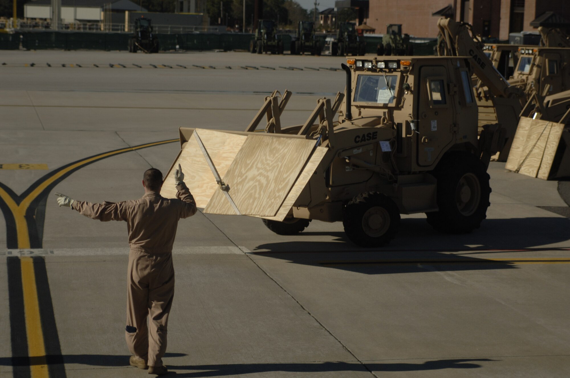 Staff Sgt. Brad Gardner directs a third-generation High Mobility Engineering Excavator into the nose of a C-5 on the Charleston AFB flightline Jan. 14. A total of eight third-generation HMEEs will be flown overseas to deployed locations in Southeast Asia to support Operation Enduring Freedom. Sergeant Gardner is with the 167th Airlift Wing Air West Virginia, National Guard. (U.S. Air Force photo/Senior Airman Timothy Taylor)
