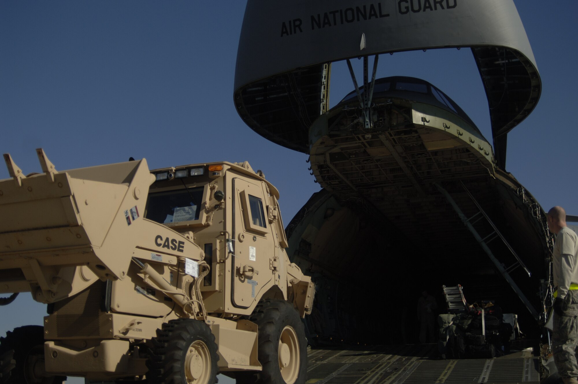 Airmen prepare to load a third-generation High Mobility Engineering Excavator onto a C-5 on the Charleston AFB flightline Jan. 14. A total of eight third-generation HMEEs will be flown overseas to deployed locations in Southwest Asia to support Operation Enduring Freedom. (U.S. Air Force photo/Senior Airman Timothy Taylor)