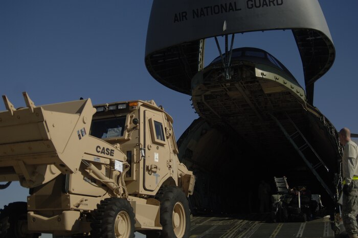 Airmen prepare to load a third-generation High Mobility Engineering Excavator onto a C-5 on the Charleston AFB flightline Jan. 14. A total of eight third-generation HMEEs will be flown overseas to deployed locations in Southwest Asia to support Operation Enduring Freedom. (U.S. Air Force photo/Senior Airman Timothy Taylor)