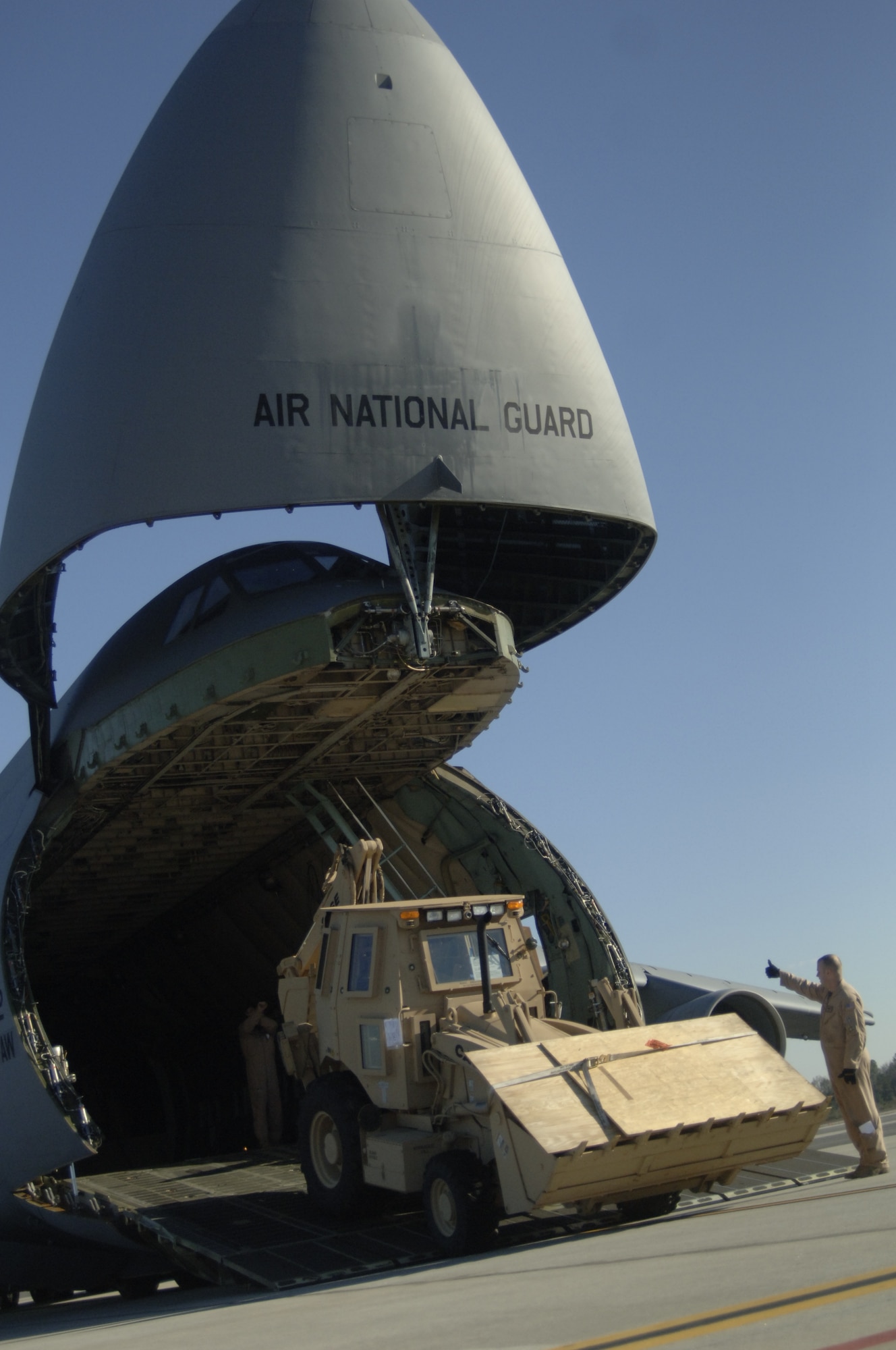 John Bauer, a contractor with Case Construction drives a third-generation High Mobility Engineering Excavator up the nose ramp of a  C-5 on the Charleston AFB flightline Jan. 14. A total of eight third-generation HMEEs will be flown overseas to deployed locations in Southwest Asia to support Operation Enduring Freedom. (U.S. Air Force photo/Senior Airman Timothy Taylor)