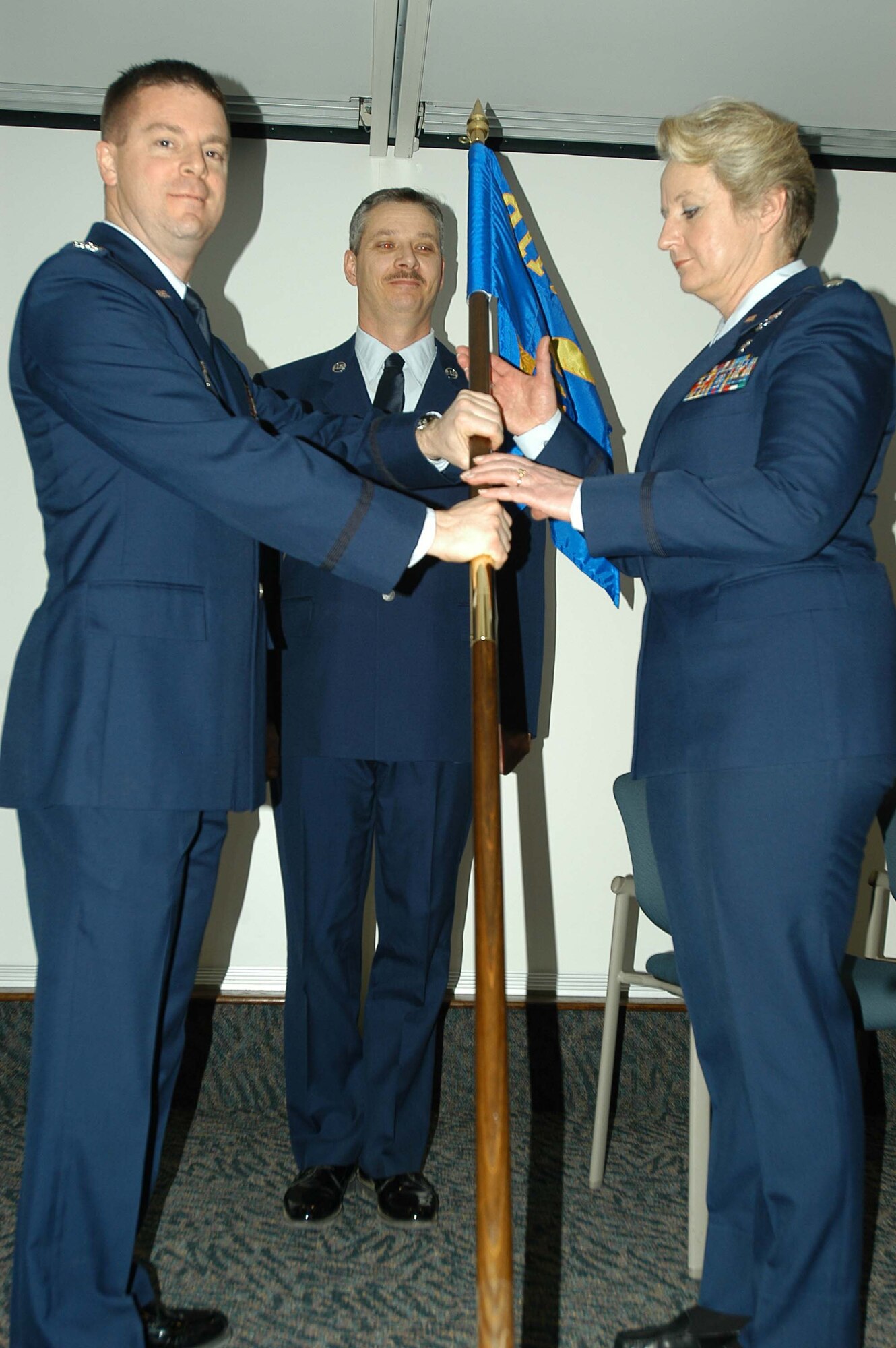 Lt. Col. Jennette Zmaeff accepts the guidon from Col. Frank Amodeo, 911th Operations Group Commander, symbolizing the assumption of command of the 911th Aeromedical Evacuation Squadron, during a ceremony held here January 10, 2009. Lt. Col. Zmaeff comes to the unit from the 446th Aeromedical Evacuation Squadron at McChord Air Force Base, Wash. (U.S. Air Force photo by Senior Airman Roberto Modelo)