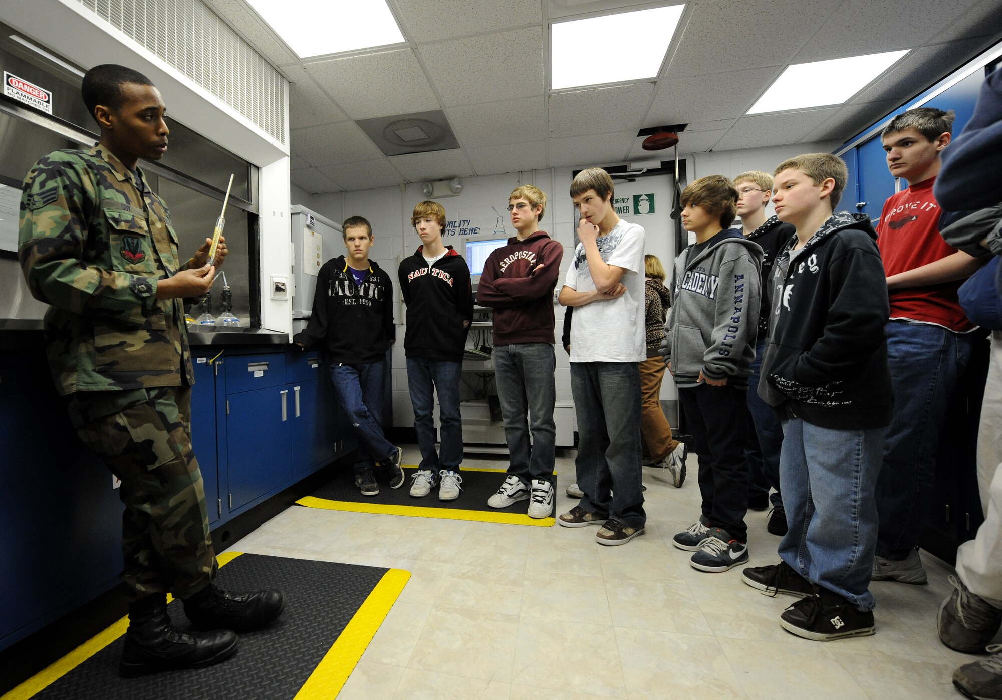 LANGLEY AIR FORCE BASE, Va. -- Students from Gildersleeve Middle School and Menchville High School listen to Senior Airman Christopher Guy, 1st Logistics Readiness Squadron fuels laboratory technician, give a presentation on jet fuel testing during a tour of Langley Jan. 13. The students are part of a youth program that emphasizes workplace readiness training, college preparation, and career exploration. (U.S. Air Force photo/Airman Rebecca Montez)