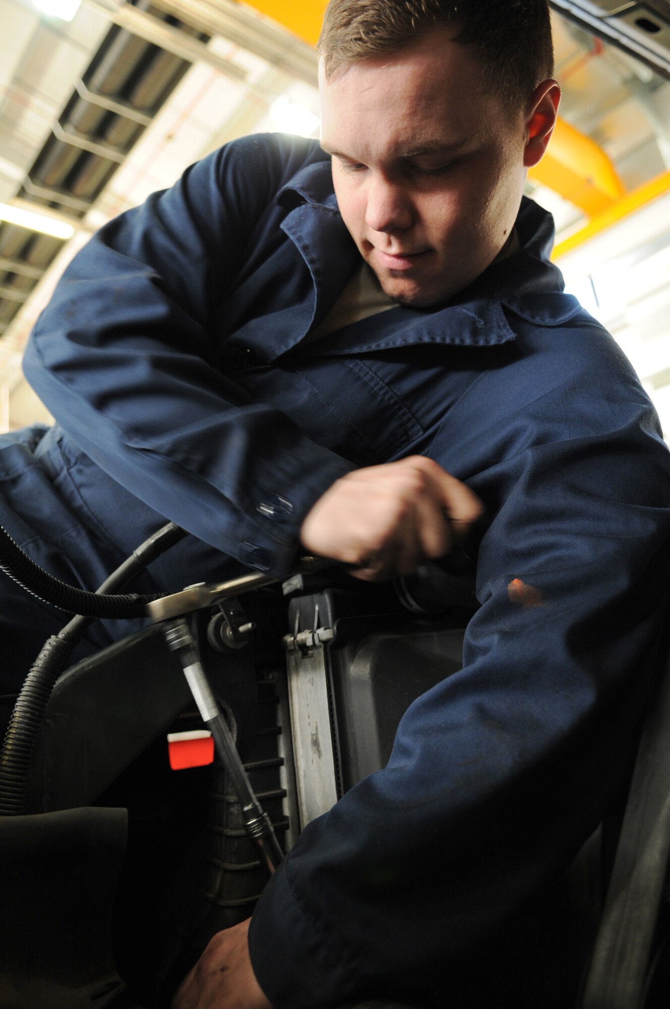 Airman 1st Class Timothy Reuwer, a vehicle maintenance technician from the 100th Logistics Readiness Squadron, tightens a clamp after repairing a power steering pump leak Dec. 18, 2008, at RAF Mildenhall, England. The vehicle maintenance squadron here performs annual inspections on more than 640 government vehicles, while also servicing and repairing vehicles daily. (U.S. Air Force photo by Staff Sgt. Jerry Fleshman)