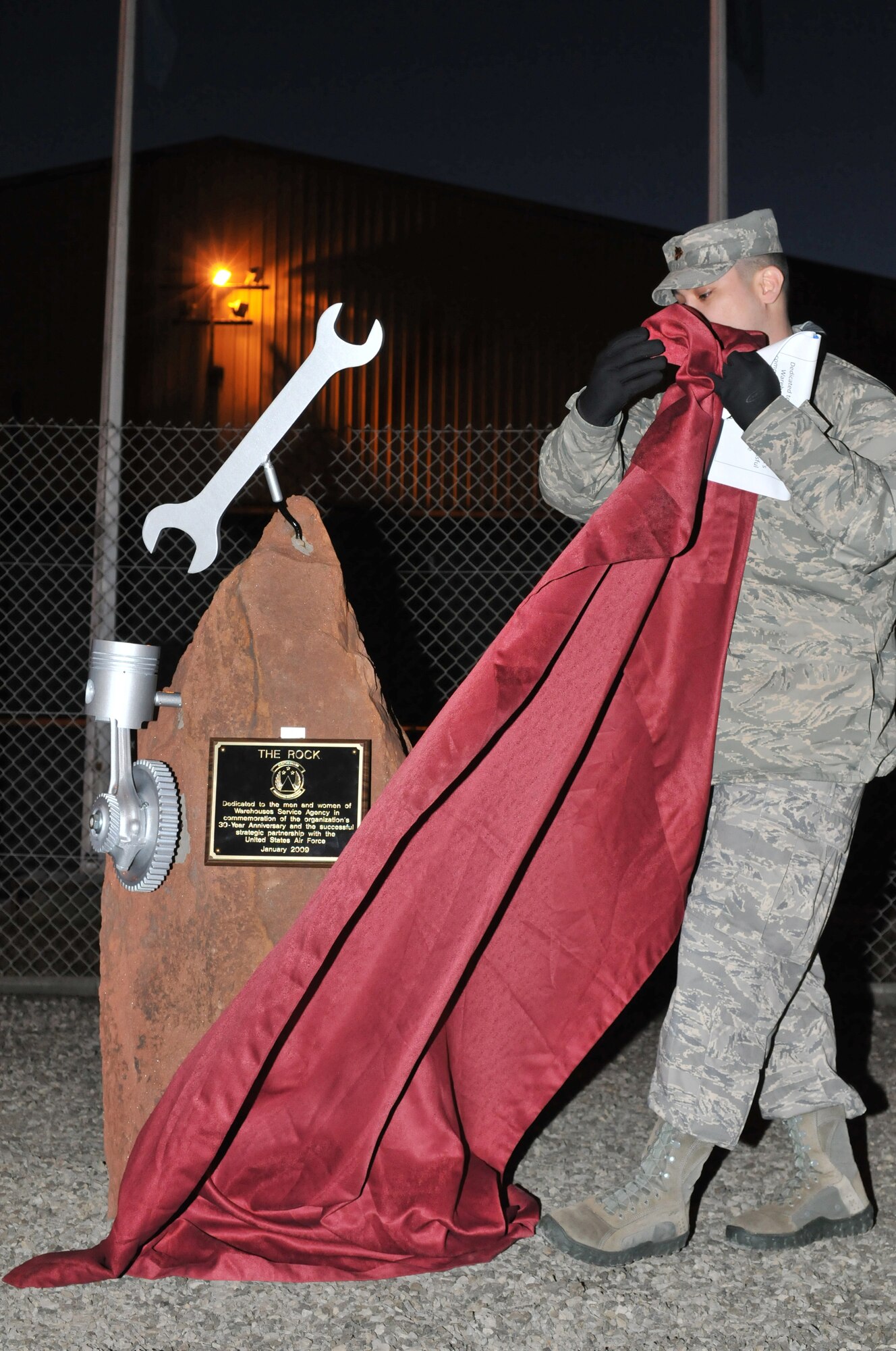 Maj. Adrian Crowley, 435th Materiel Maintenance Squadron commander, unveils the "rock" at the Warehouse Services Agency's 30th Anniversary in Sanem, Luxembourg, Jan. 8, 2009. The ?rock? was given to the WSA in commemoration of the organization?s strategic partnership with the Air Force. (U.S. Air Force photo by Senior Airman Nathan Lipscomb)