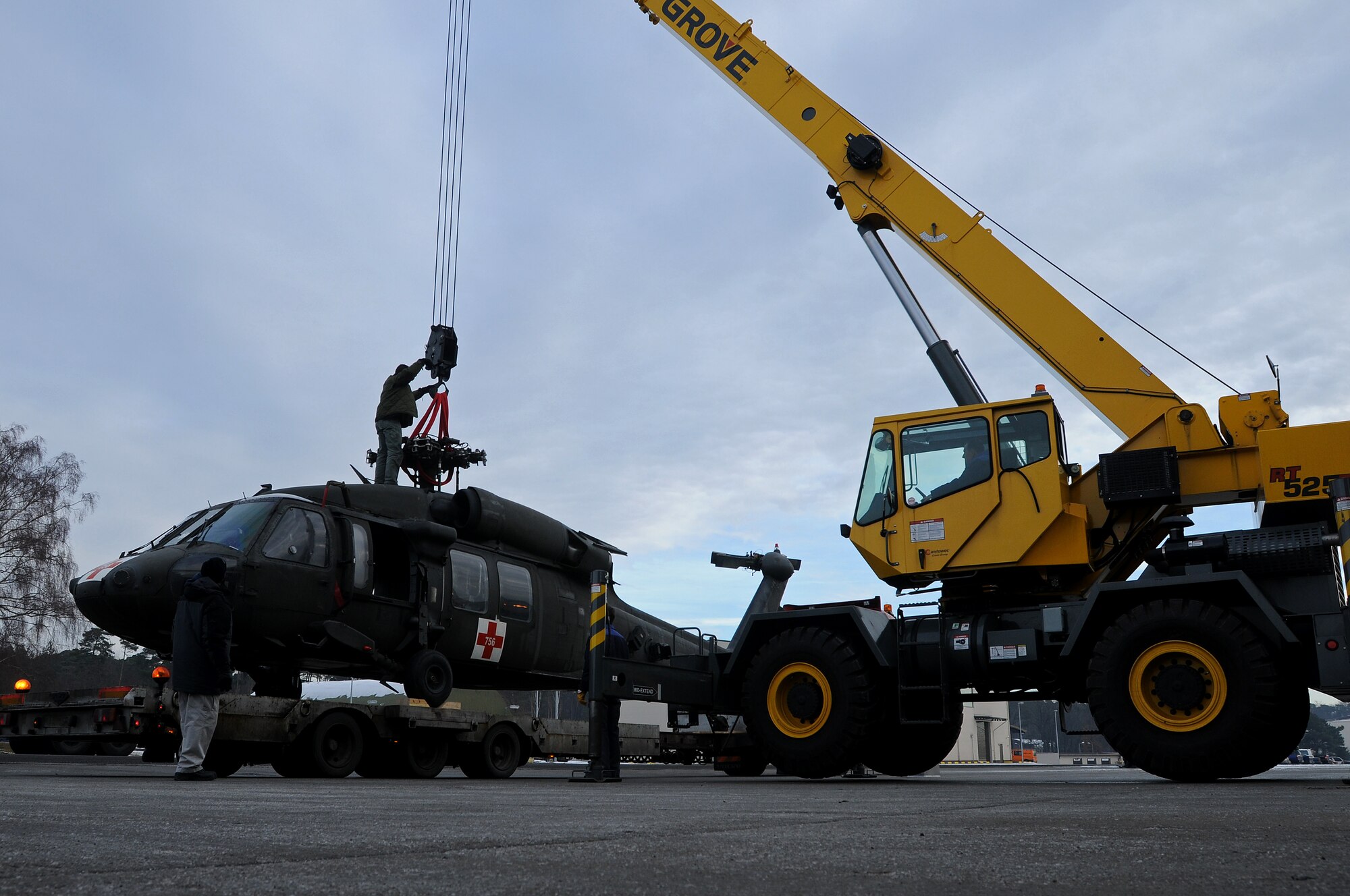 DynCorp International personnel prepare an Army Sikorsky UH-60 Black Hawk for transport to Coleman Barracks Jan. 13, 2009, from Ramstein Air Base. The Black Hawk was brought from Iraq to undergo special maintenance.  (U.S. Air Force photo by Airman 1st Class Kenny Holston)