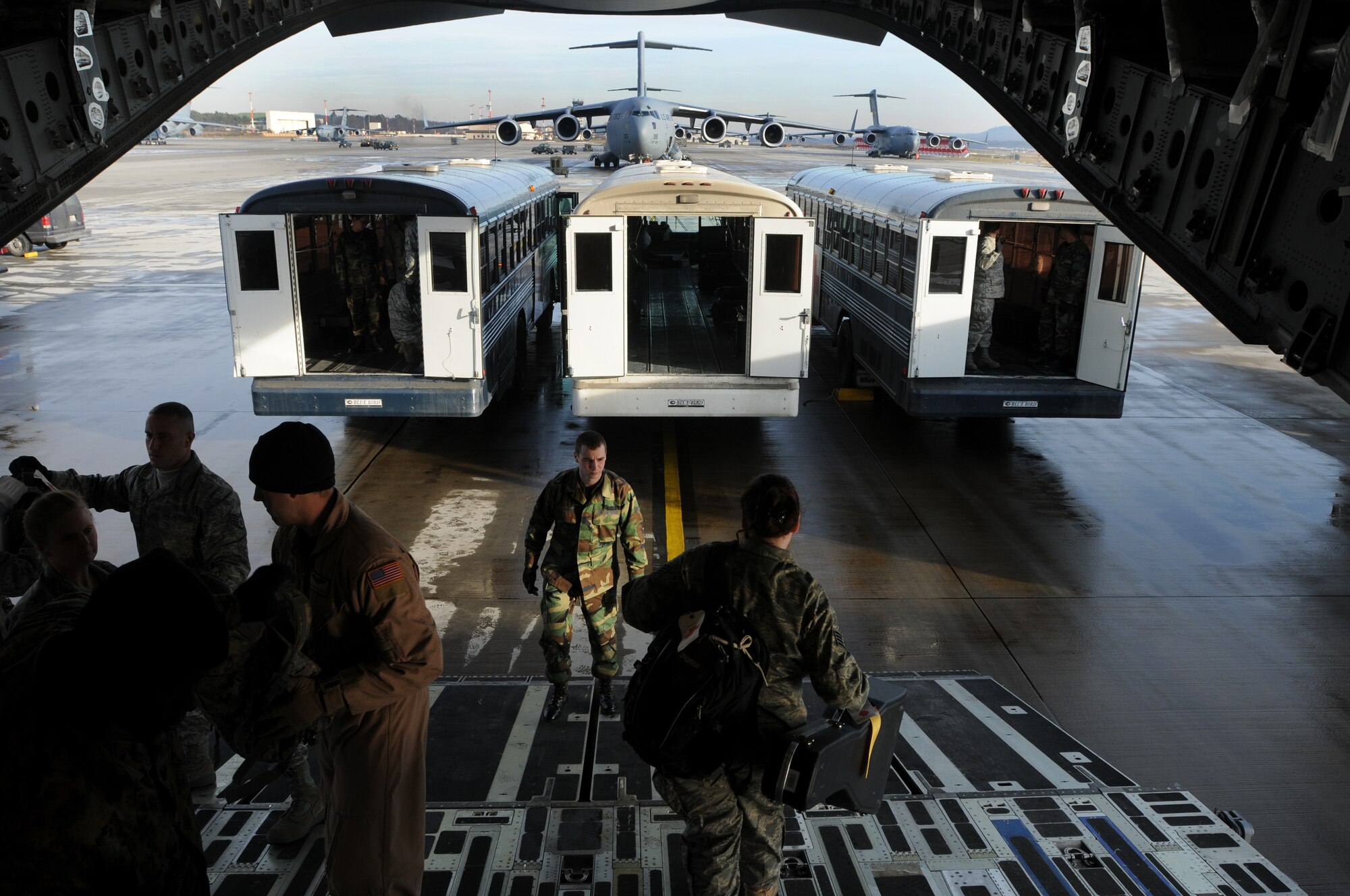 Members from the 435th Contingency Aeromedical Staging Facility off-load patient's gear Jan. 13, 2009, at Ramstein Air Base before off-loading patients returning from Balad Air Base, Iraq. More than 30 patients who were wounded in battle were flown back from the Area of Operation. (U.S. Air Force photo by Airman 1st Class Kenny Holston)  