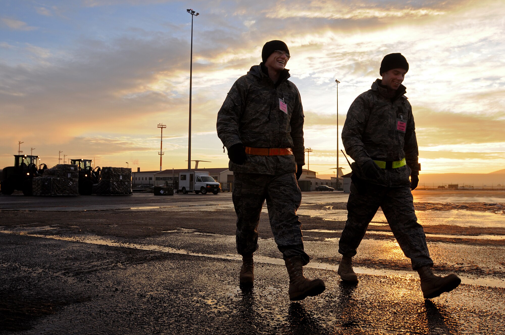Airman 1st Class Kelly Long (left) and Airman 1st Class Steven Rust, 435th Vehicle Readiness Squadron, make their way across the Joint Mobility Processing Center yard after securing cargo in support of an operational readiness exercise at Ramstein Air Base Jan 13, 2009. The exercise prepared Airmen stationed at Ramstein for real world missions and events. (U.S. Air Force photo by Airman 1st Class Kenny Holston)  