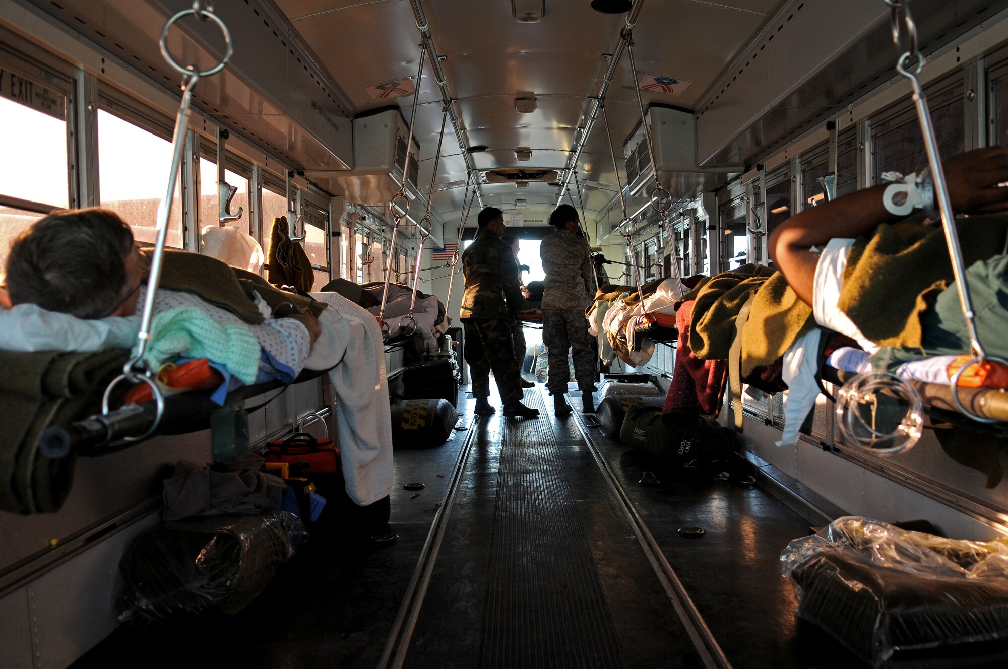 Members from the 435th Contingency Aeromedical Staging Facility load patients onto the medical busses at Ramstein Air Base returning from Balad Air Base, Iraq, Jan. 13, 2009. More than 30 patients who were wounded in battle were flown back from the Area of Operation. (U.S. Air Force photo by Grovert Fuentes-Contreras)