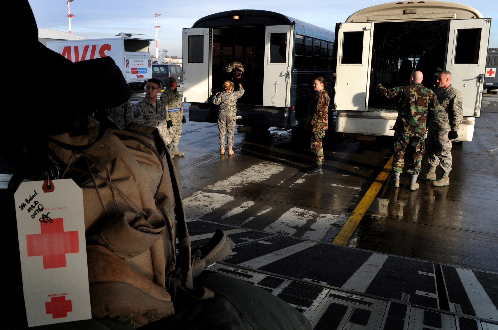 Members from the 435th Contingency Aeromedical Staging Facility load patients onto the medical busses at Ramstein Air Base returning from Balad Air Base, Iraq, Jan. 13, 2009. More than 30 patients who were wounded in battle were flown back from the Area of Operation. (U.S. Air Force photo by Grovert Fuentes-Contreras)