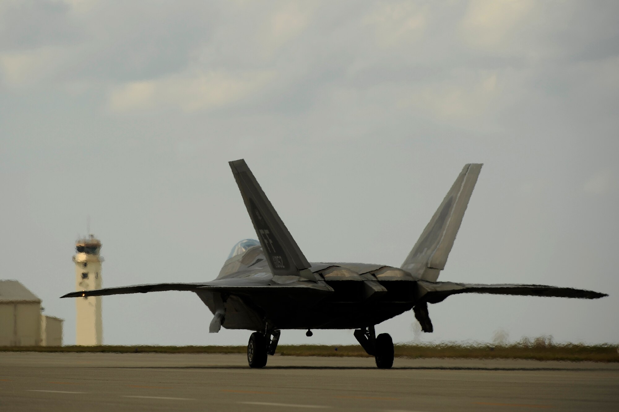 Lt. Col. James Croxton, 27th Fighter Squadron pilot, taxis an F-22A Raptor down the ramp for another local mission on Jan. 15 at Kadena Air Base, Japan. The F-22's are deployed from the 27th Fighter Squadron Langley Air Force Base, Va. in support of U.S. Pacific Command. (U.S. Air Force photo/Master Sgt. Andy Dunaway)