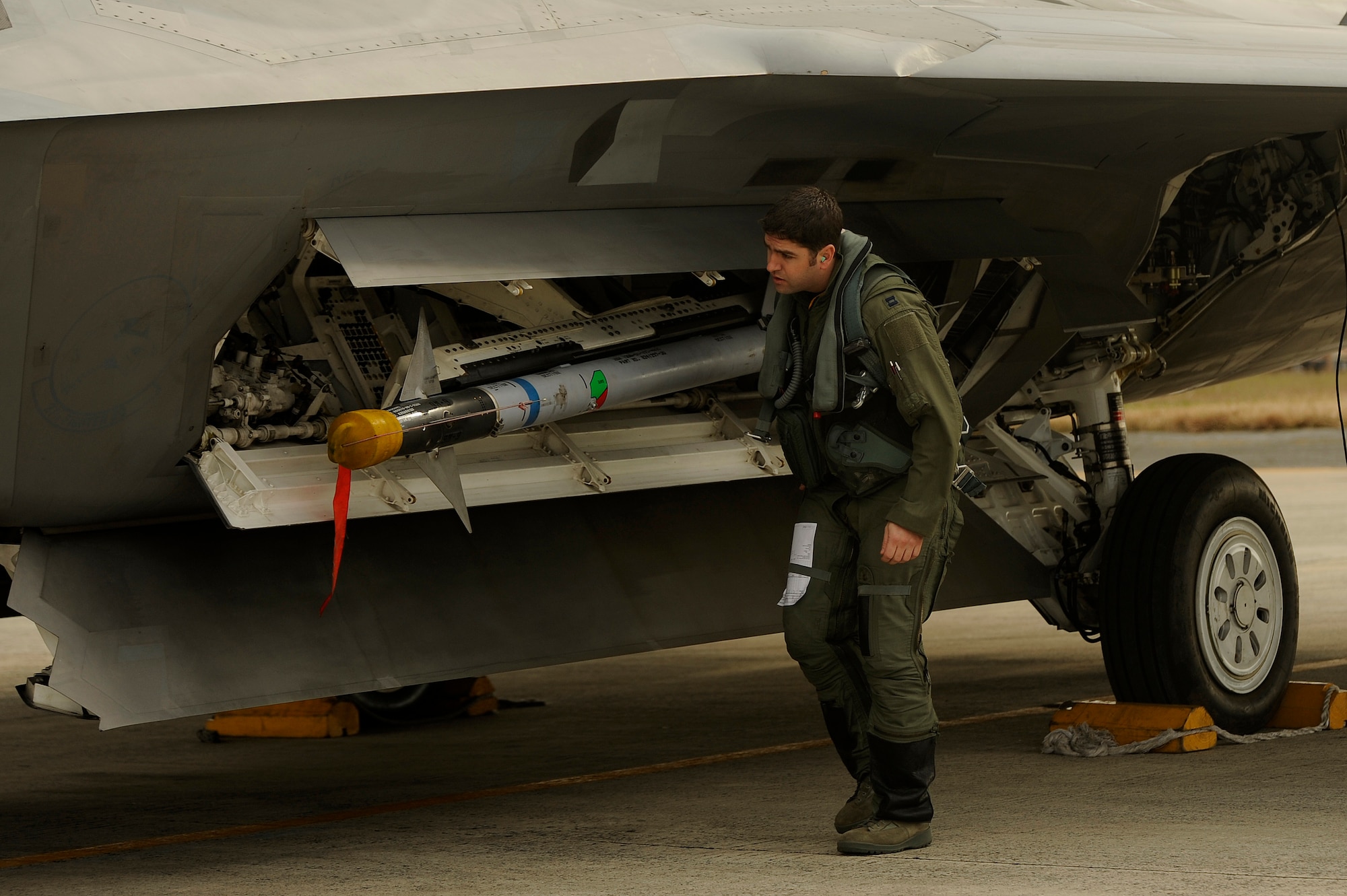Capt. Jonathan Airhart, 27th Fighter Squadron pilot, performs a walk around an F-22A Raptor prior to a local mission on Jan. 14 at Kadena Air Base, Japan. The F-22A is deployed from the 27th Fighter Squadron Langley Air Force Base, Va. in support of U.S. Pacific Command. (U.S. Air Force photo/Master Sgt. Andy Dunaway)