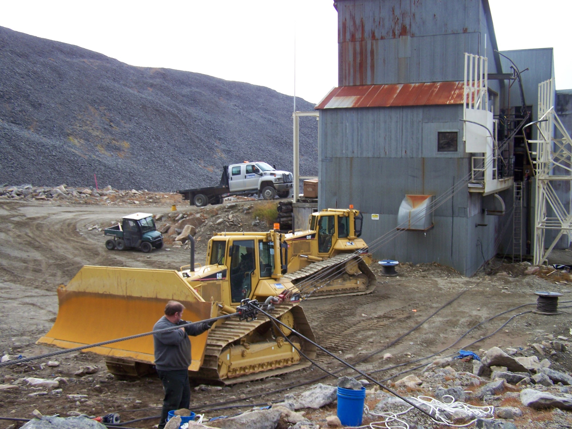 Denny Hodges, aerial tram specialist, monitors the initial pull on the tram haul cable after new cable was installed at the Cape Romanzof Long Range Radar Station. The tram connects the upper and lower camps. Both the tram and a road are used by the employees to access the upper camp depending on weather conditions and the work required.