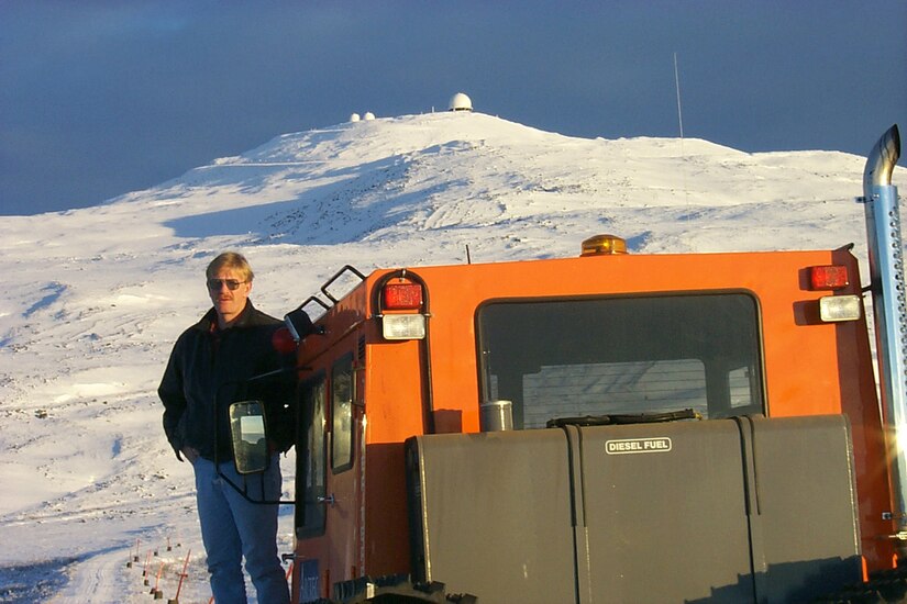 Rich Anderson, Indian Mountain Long Range Radar Station sector lead, pauses to look back at lower camp as he makes his way by snow cat up to the radar tower at upper camp.  It is a 10 mile trip by road from lower camp to upper camp.