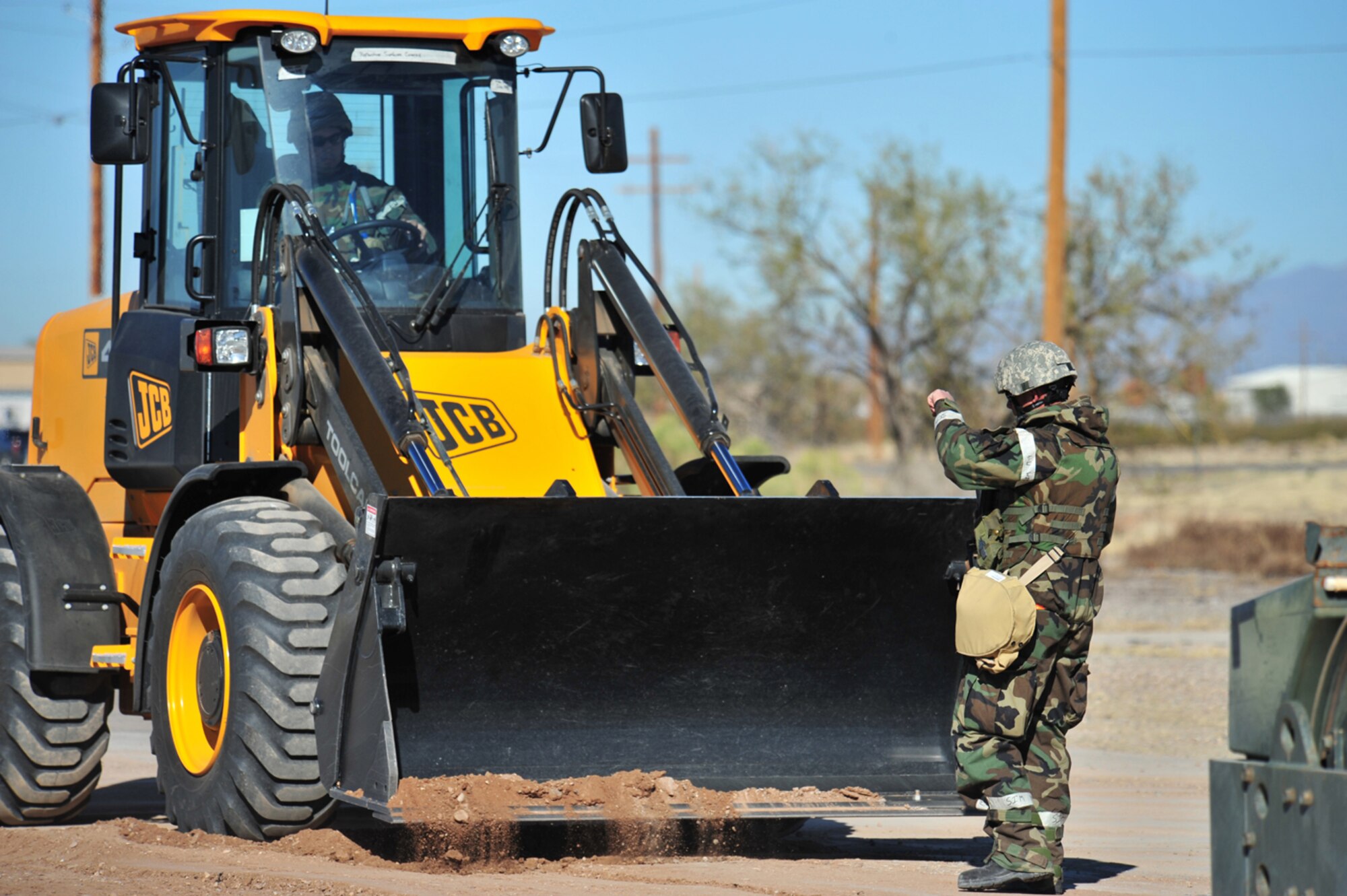 Staff Sgt. Craig Nordman (right) directs Senior Airman Doug Cabral, both members of of the 355th Civil Engineer Squadron, while repairing a road crater during the Phase II Operational Readiness Exercise here Jan. 15. (U.S. Air Force photo/Senior Airman Noah R. Johnson)
