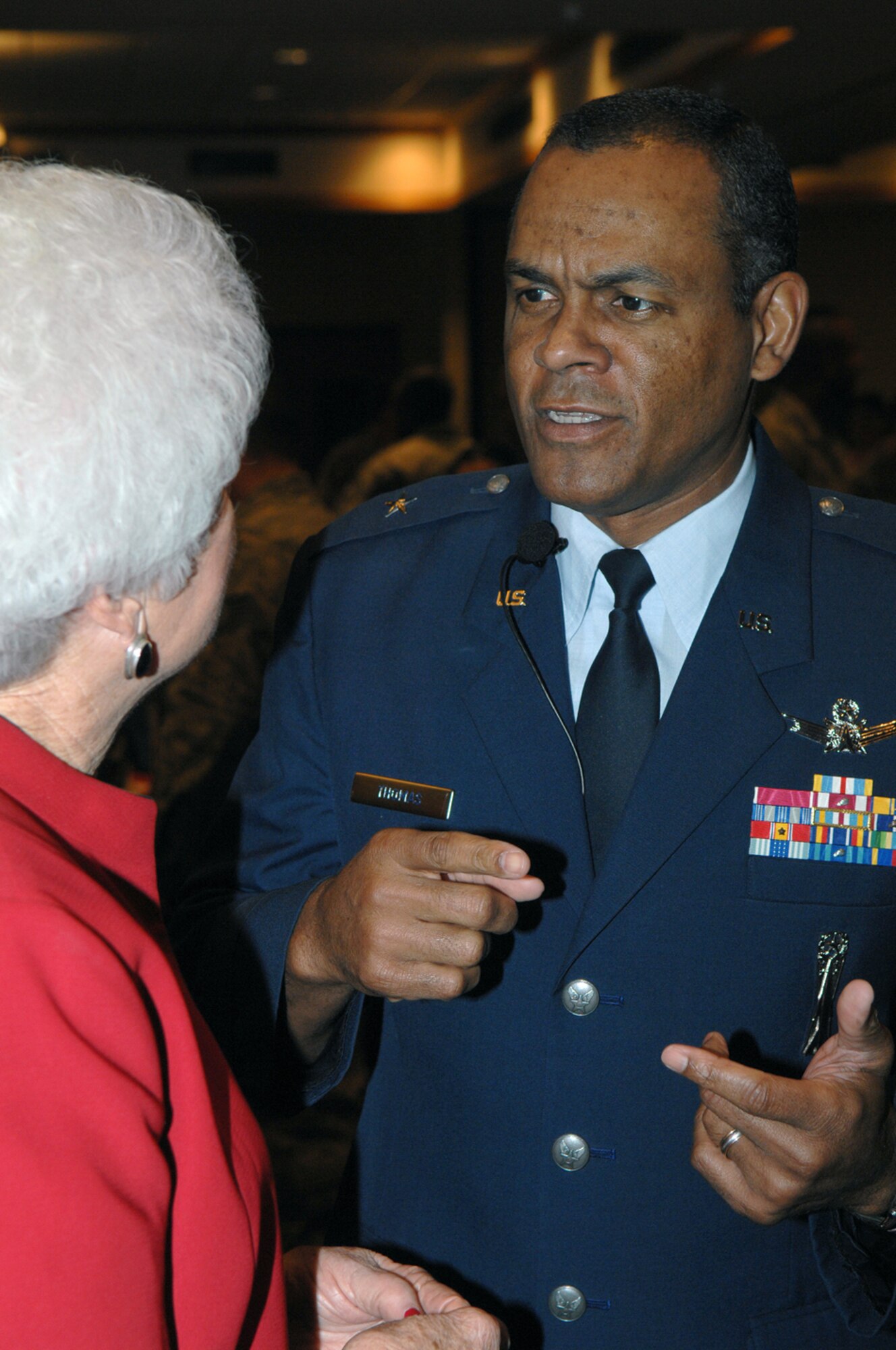 Brig. Gen. Everett H. Thomas, commander of the Air Force Nuclear Weapons Center at Kirtland Air Force Base, N.M.,  speaks to base wingman, Ms. Tuts Green, during the Martin Luther King, Jr. observance luncheon at Holloman Air Force Base, N.M., Jan. 15. General Thomas was the guest speaker at the luncheon. (U.S. Air Force photo/Senior Airman Anthony Nelson)